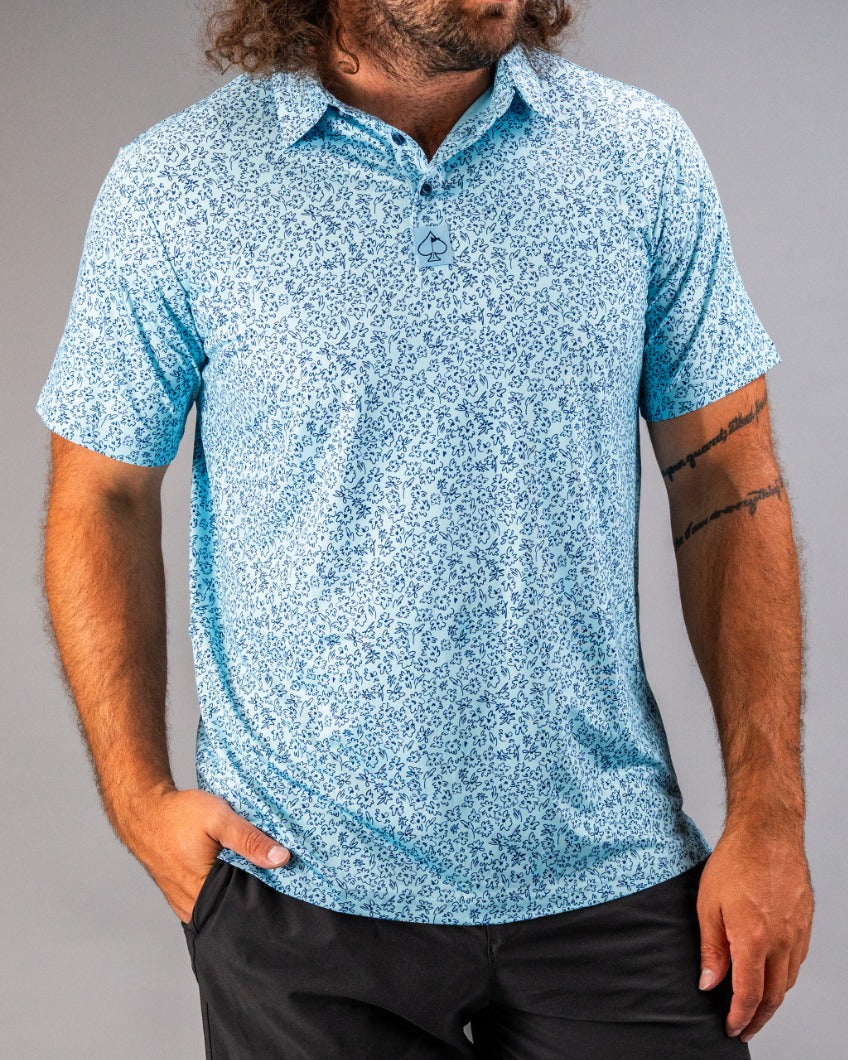 Men's short-sleeve golf shirt in light blue featuring a flower doodle pattern, perfect for stylish performance on the course.