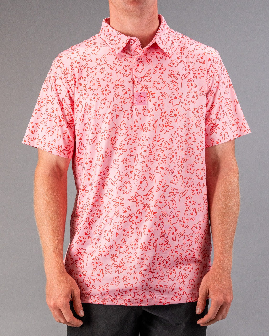 Men's short-sleeve golf shirt in pink with a playful flower doodle pattern, perfect for a stylish day on the course.