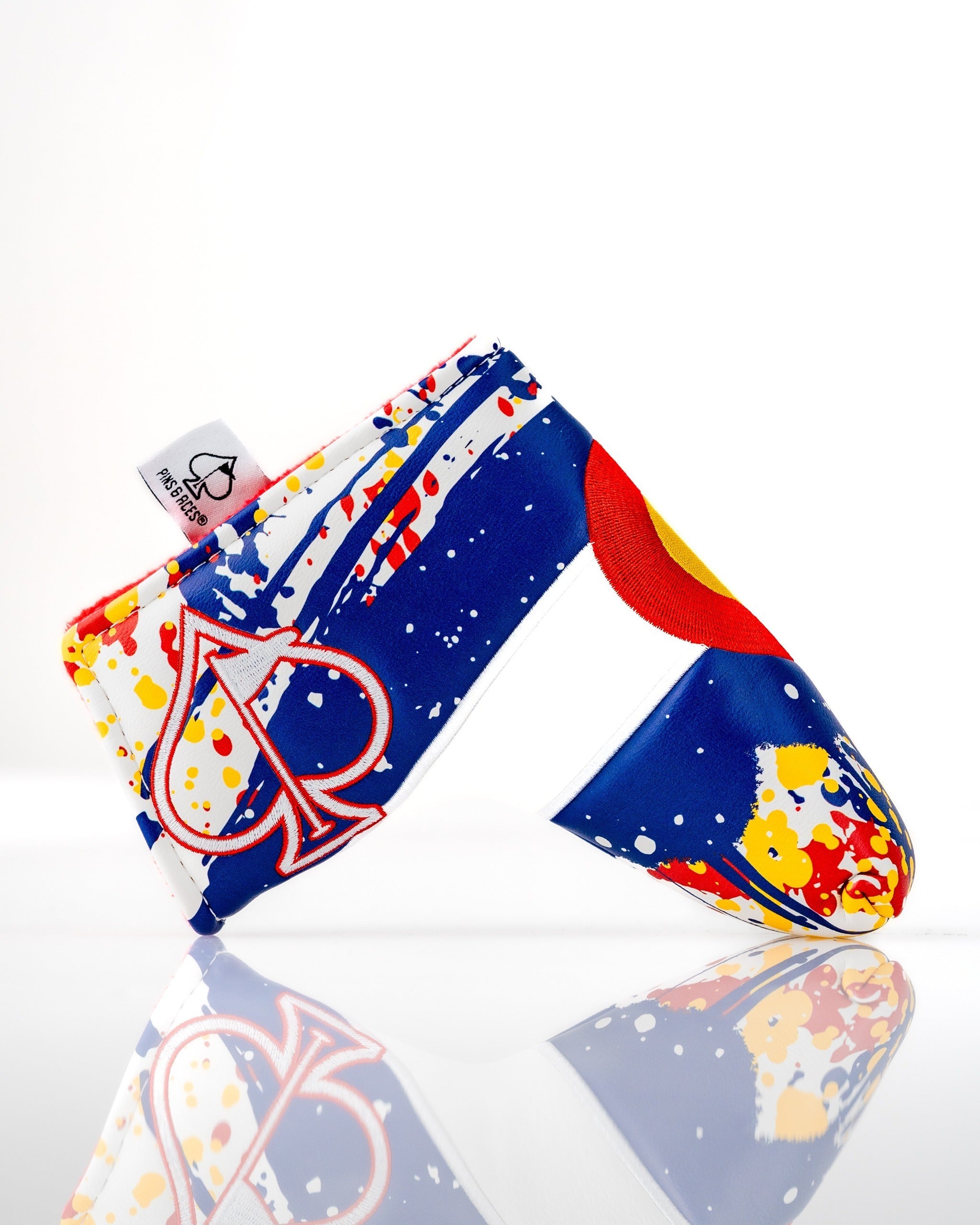 Bold Colorado 2.0 blade putter cover featuring a vibrant design with splashes of blue, red, and yellow for standout style.