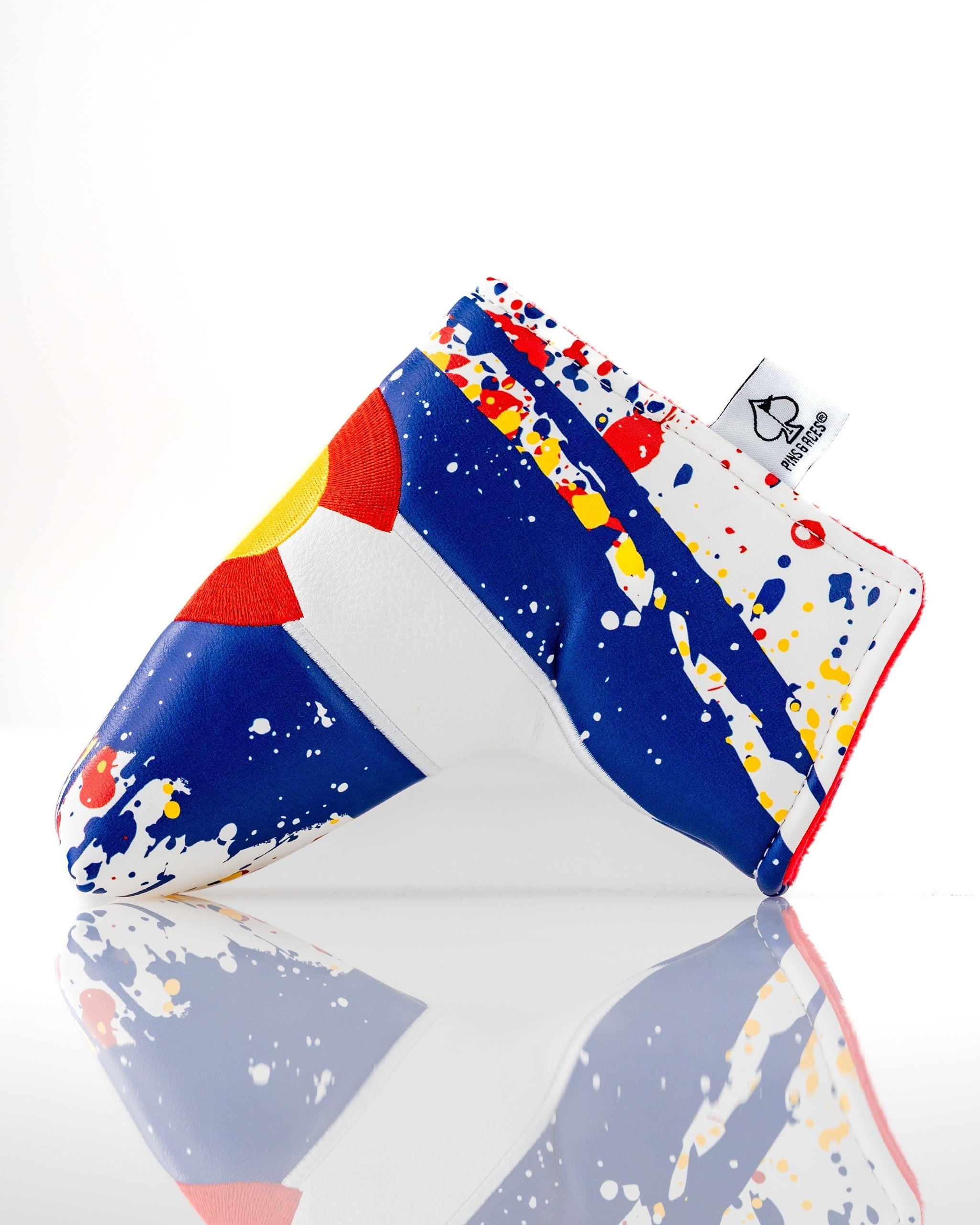 Bold Colorado 2.0 blade putter cover featuring a colorful design with splashes of blue, red, and yellow for standout style.