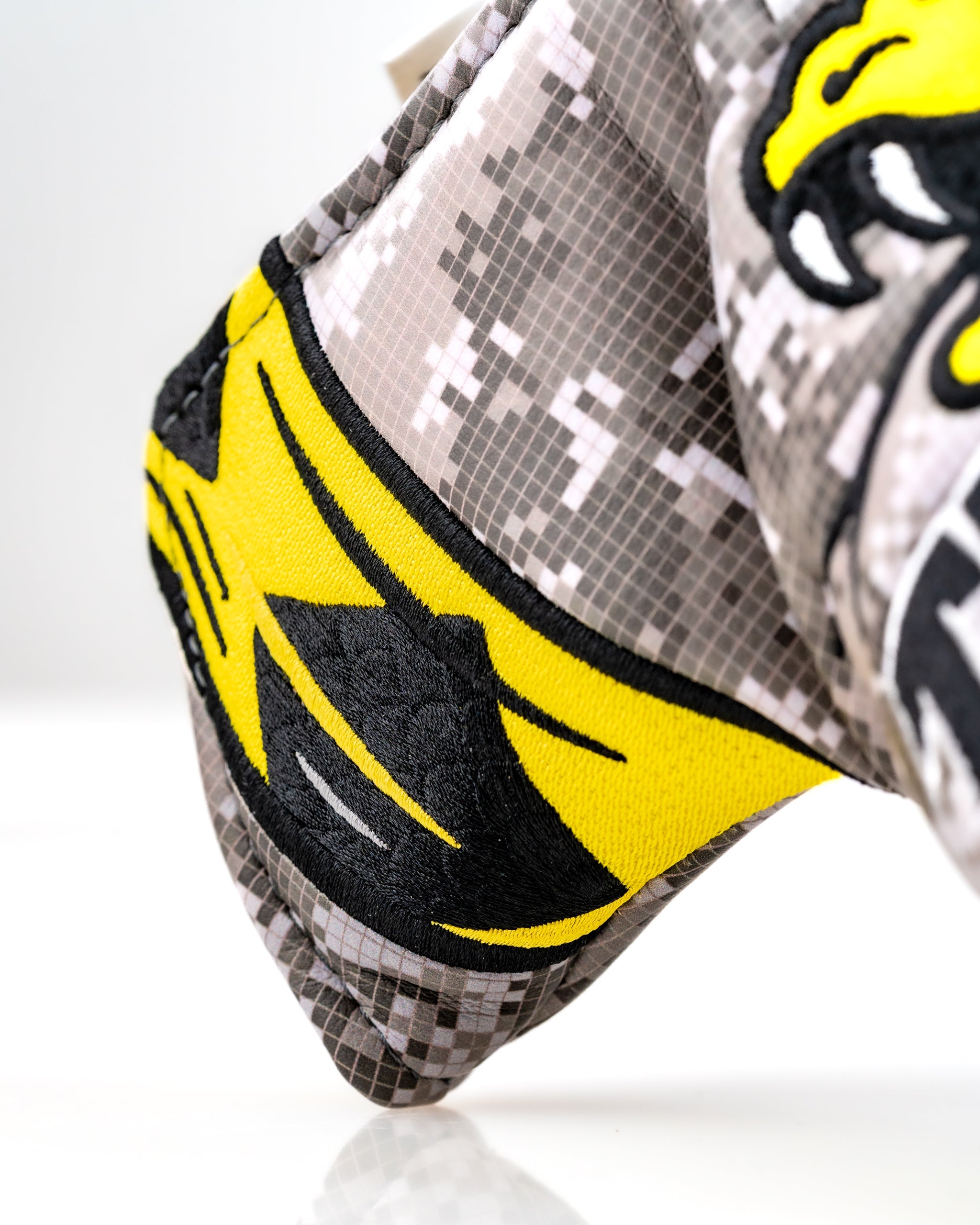 Close-up of the Don't Tread On Me 2.0 Blade Putter Cover featuring a bold yellow design on a camo background.