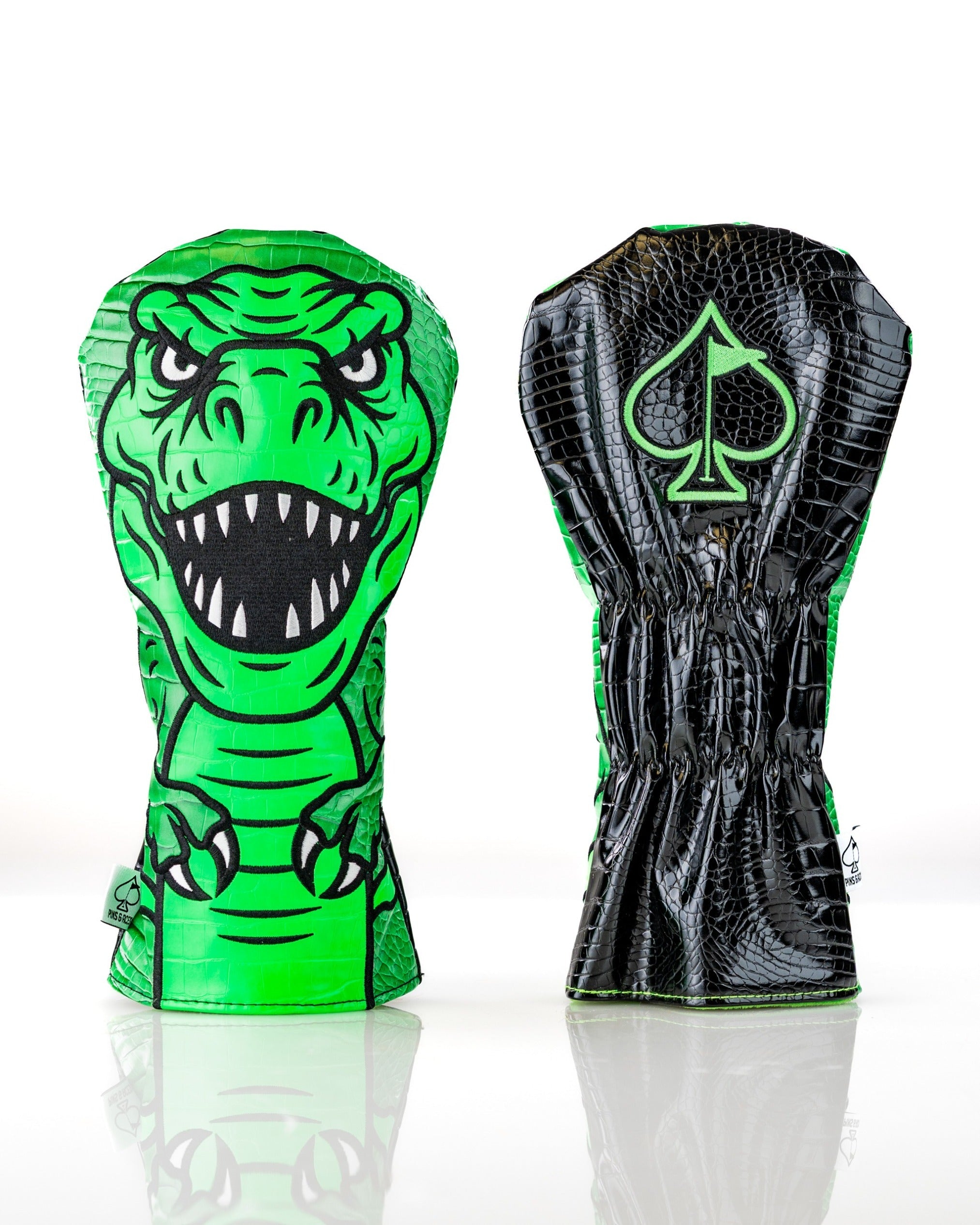 Bold T-Rex driver cover featuring a vibrant green dinosaur design on one side and a sleek black crocodile texture on the other.