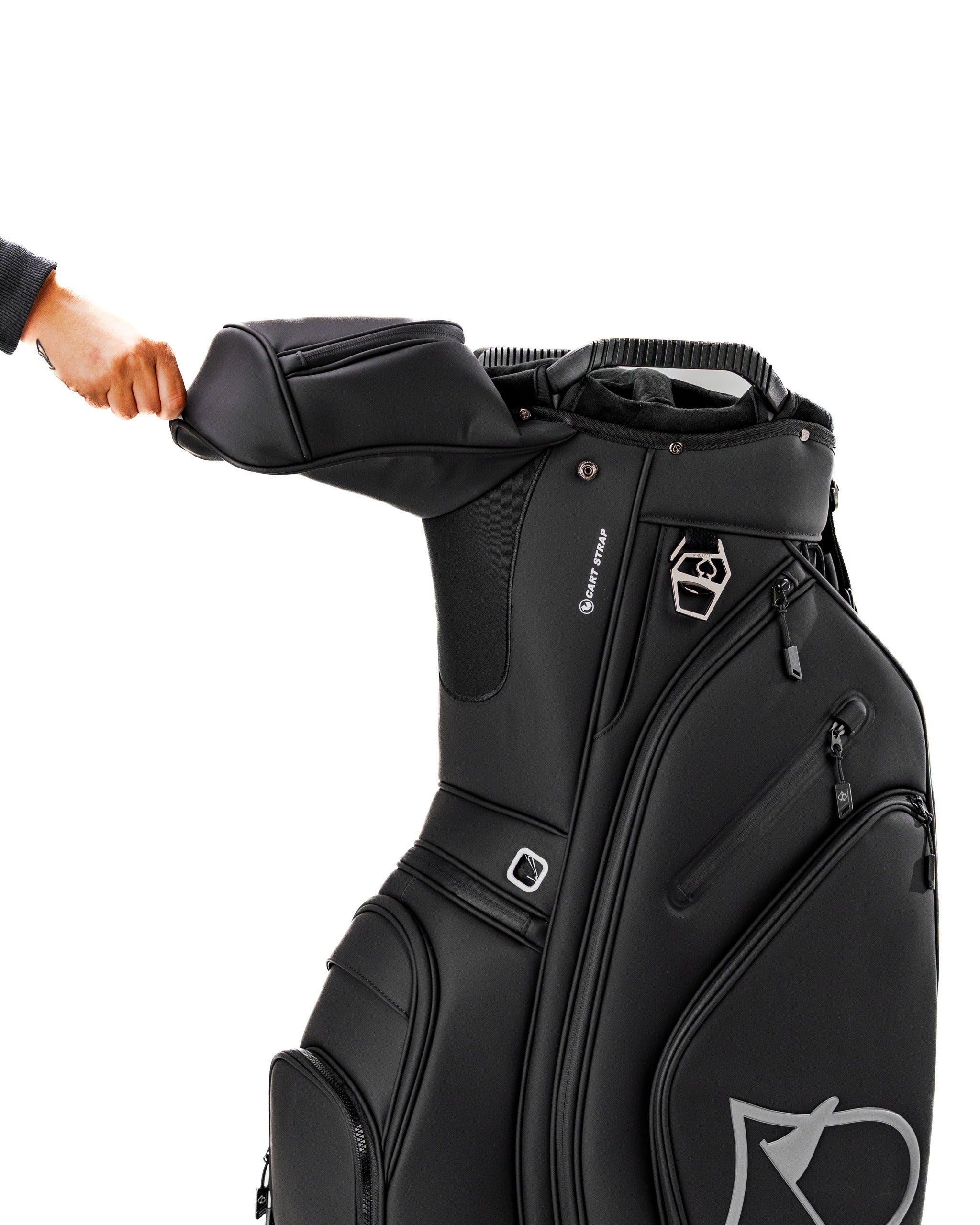 Black Player Preferred™ cart bag with a hand adjusting the top compartment, showcasing its sleek design and functionality.