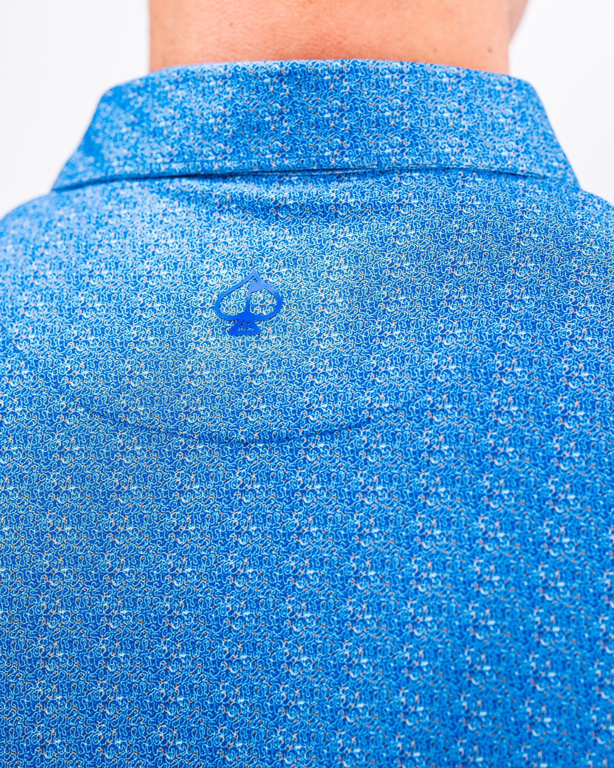 Player Preferred™ Polo in Cosmic Swirl design featuring a colorful, abstract pattern.