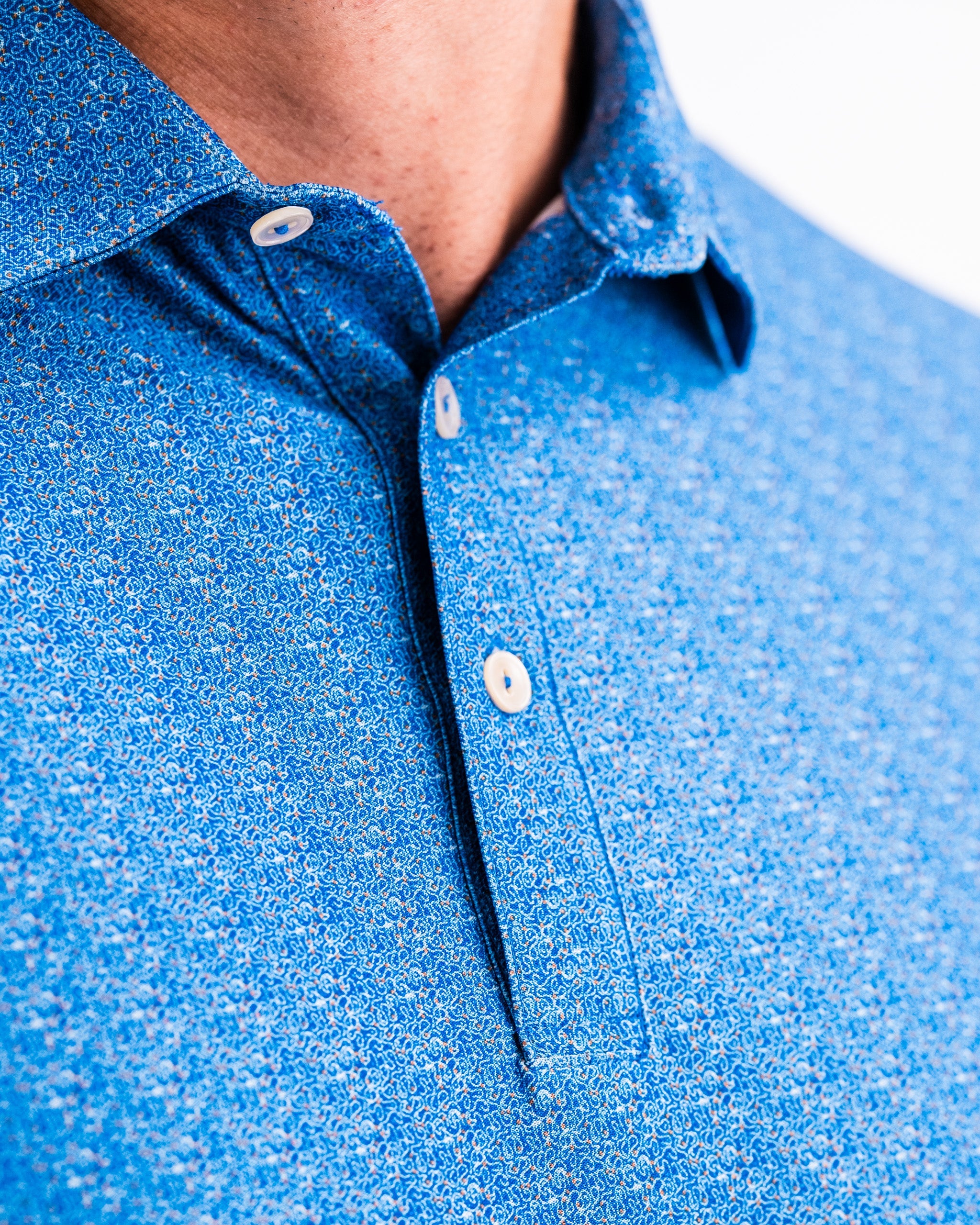 Player Preferred™ Polo in Cosmic Swirl design, featuring a vibrant multicolor pattern, short sleeves, and a classic collar.
