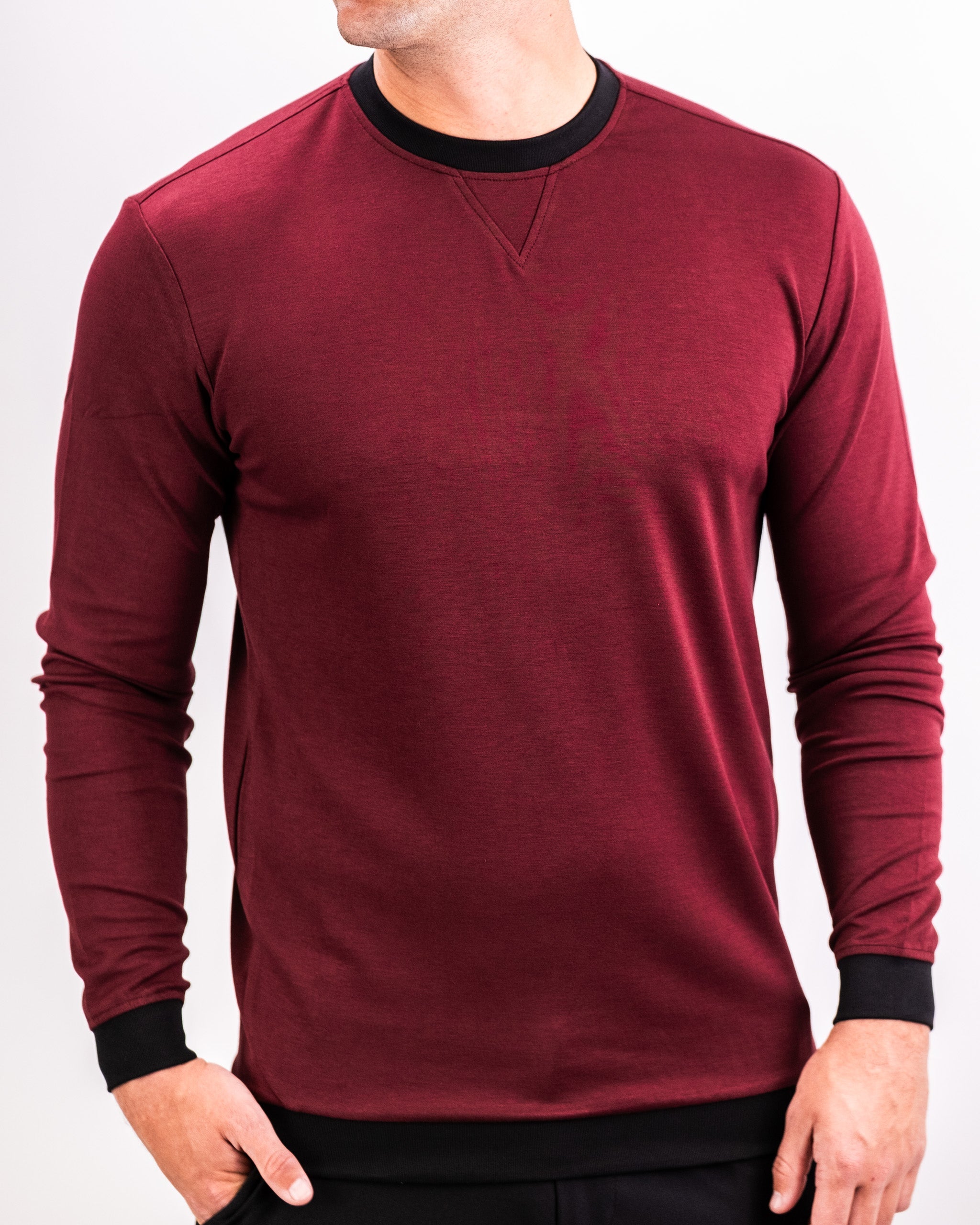 Men's maroon crewneck sweatshirt with black collar and cuffs, featuring a subtle textured fabric and relaxed fit.