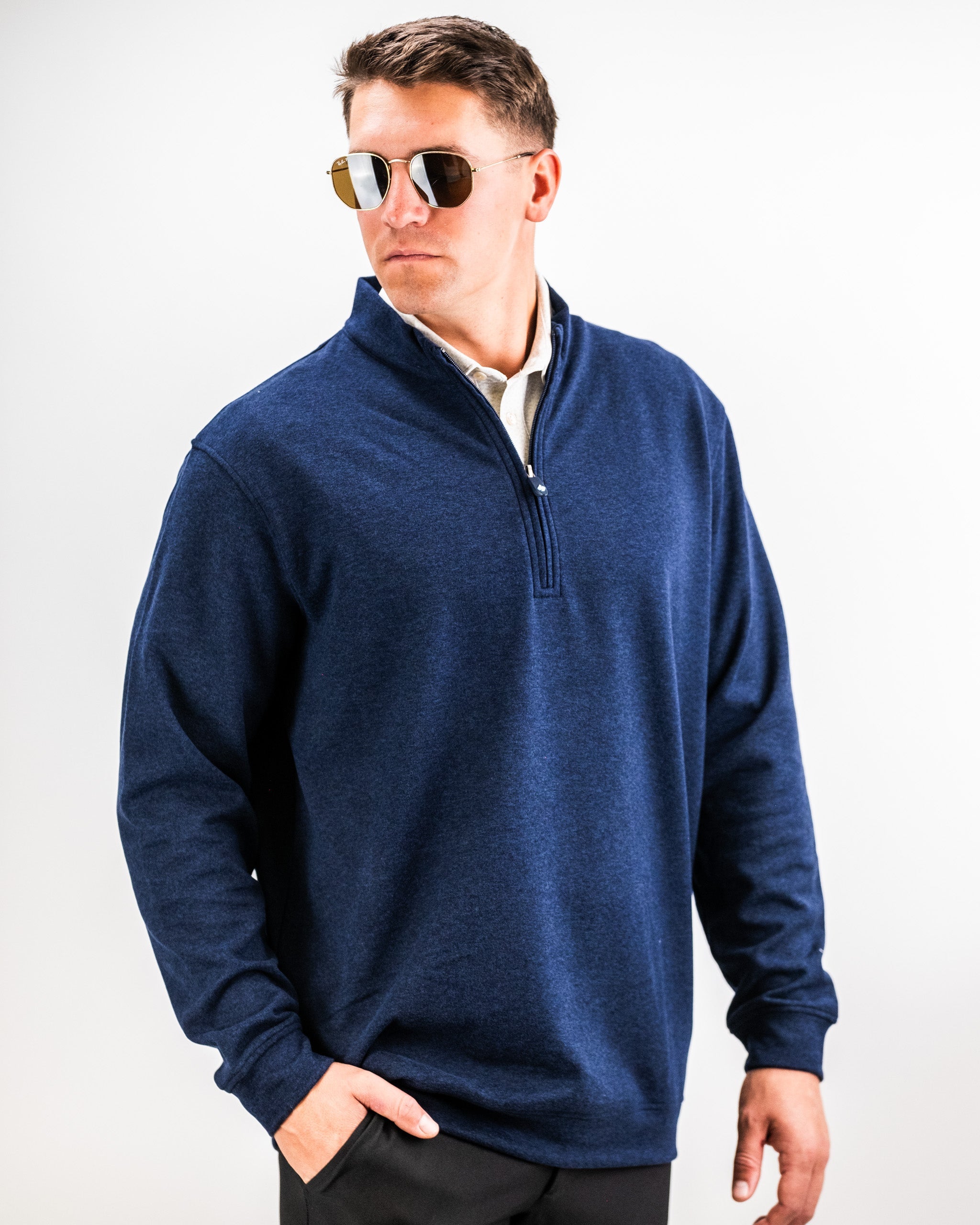 Man wearing a navy heathered Player Preferred™ Pullover with a quarter-zip collar, standing against a white background.