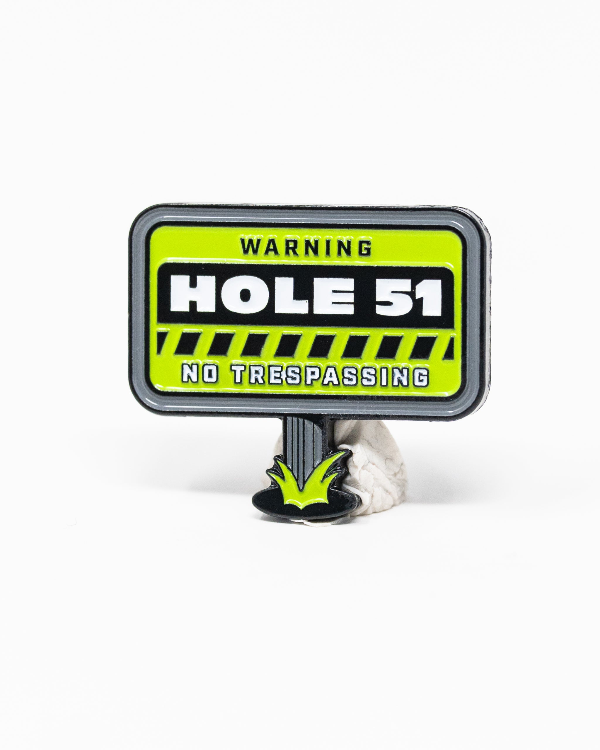 HEYDUDE Hole 51 Ball Marker with a circular design and colorful graphic, featuring the brand logo.