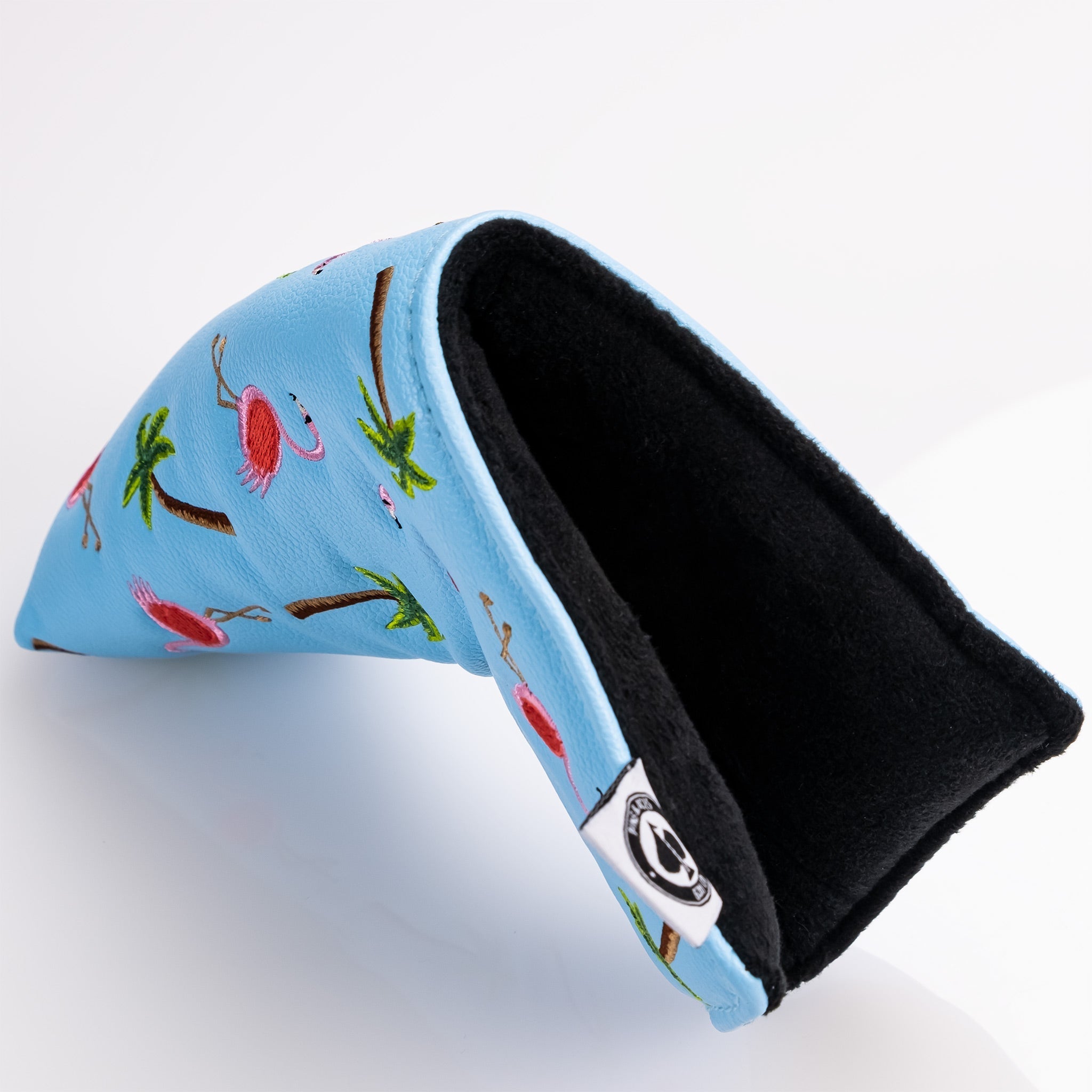 Dancing Flamingos blade putter cover showcasing a vibrant pink flamingo design with colorful accents on a black background.