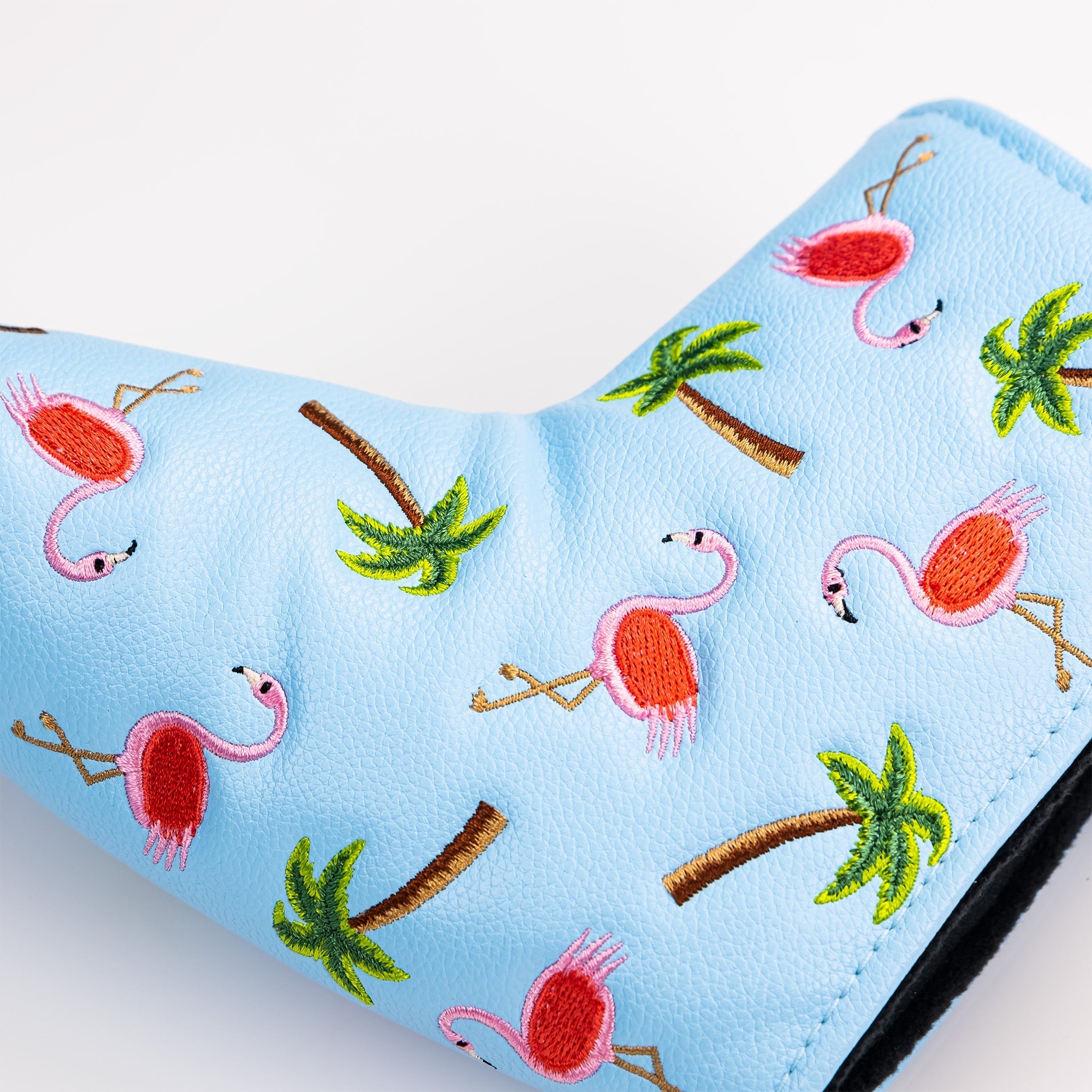 Dancing Flamingos blade putter cover featuring a vibrant pink flamingo pattern on a black background.