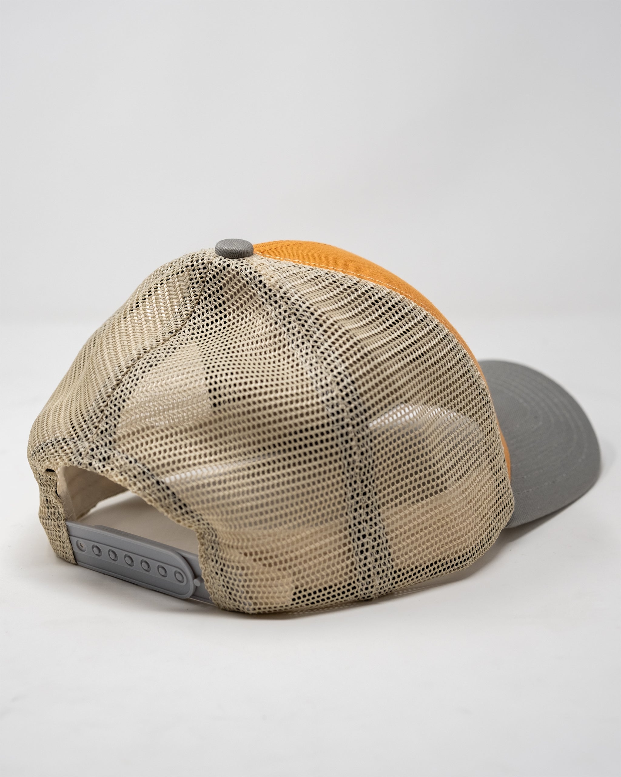 Trucker hat in bright orange with "Range Rat" text design, featuring a mesh back and adjustable snap closure.