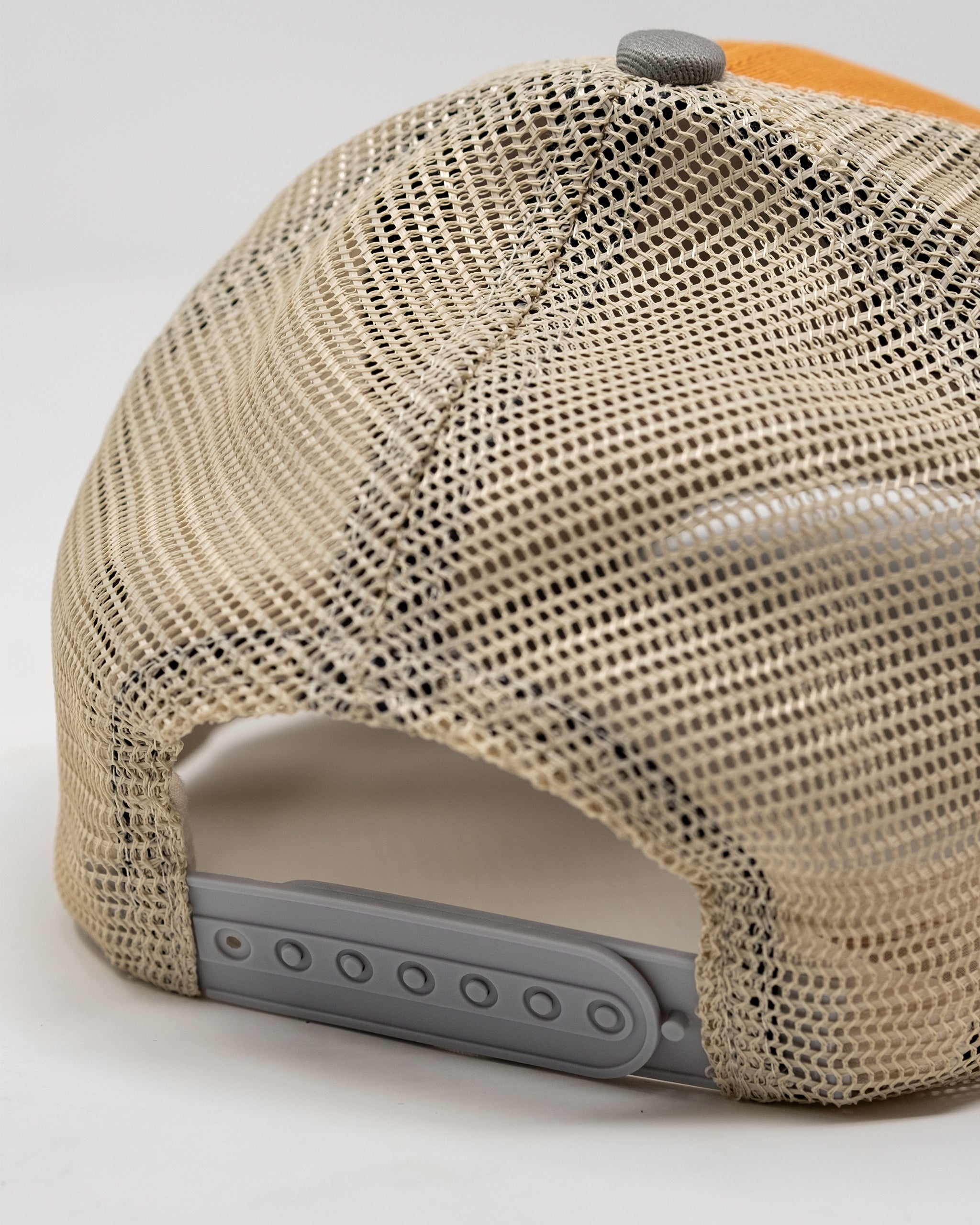 Orange trucker hat with "Range Rat" embroidery on the front, featuring a mesh back and adjustable snap closure.