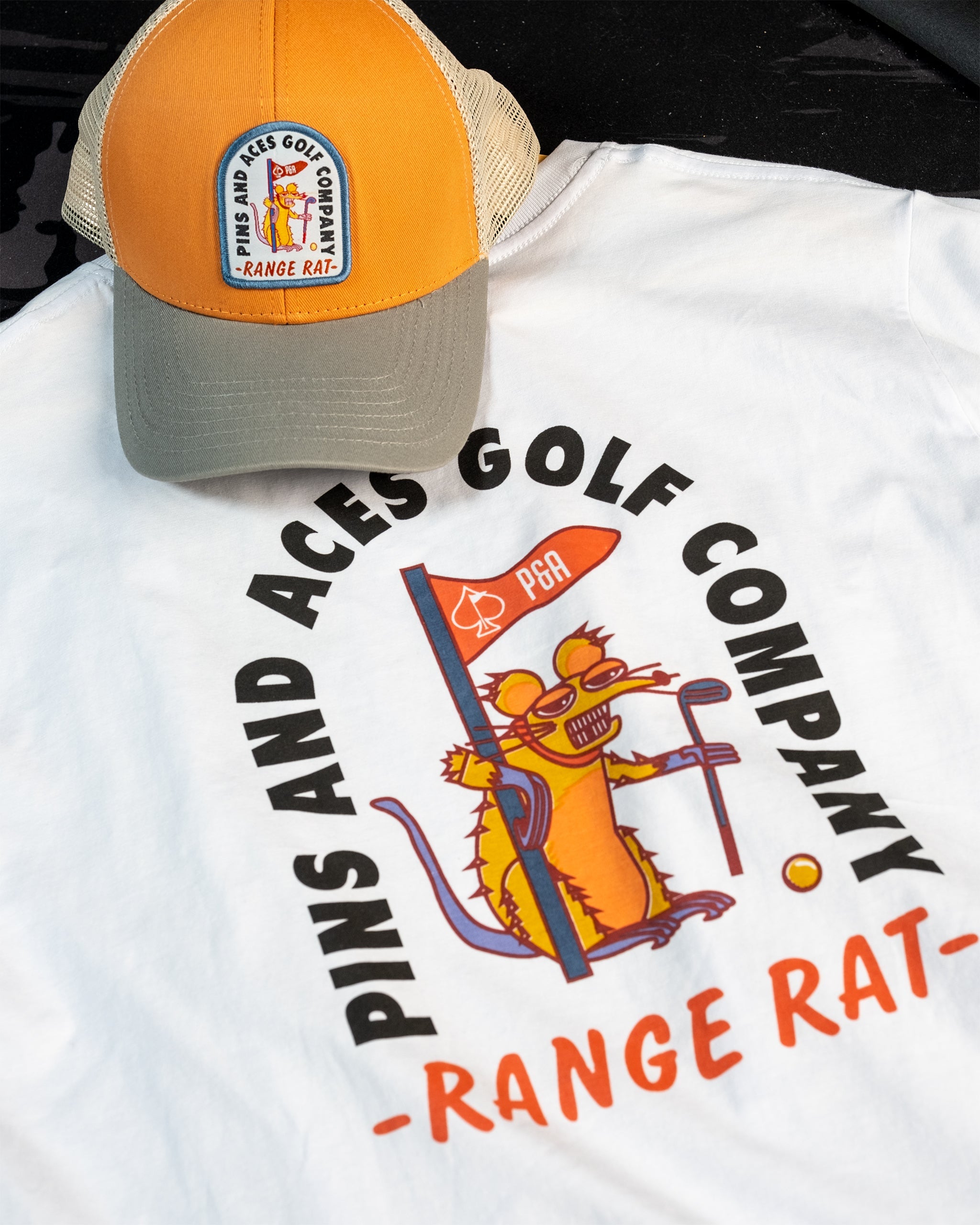 Orange trucker hat featuring a "Range Rat" graphic and mesh back design.