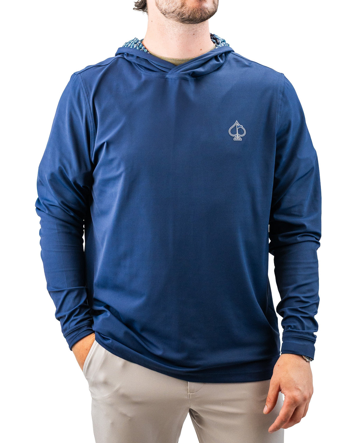 Blue lightweight hoodie with a small spade logo, featuring a patterned lining inside the hood, perfect for bold golf style.