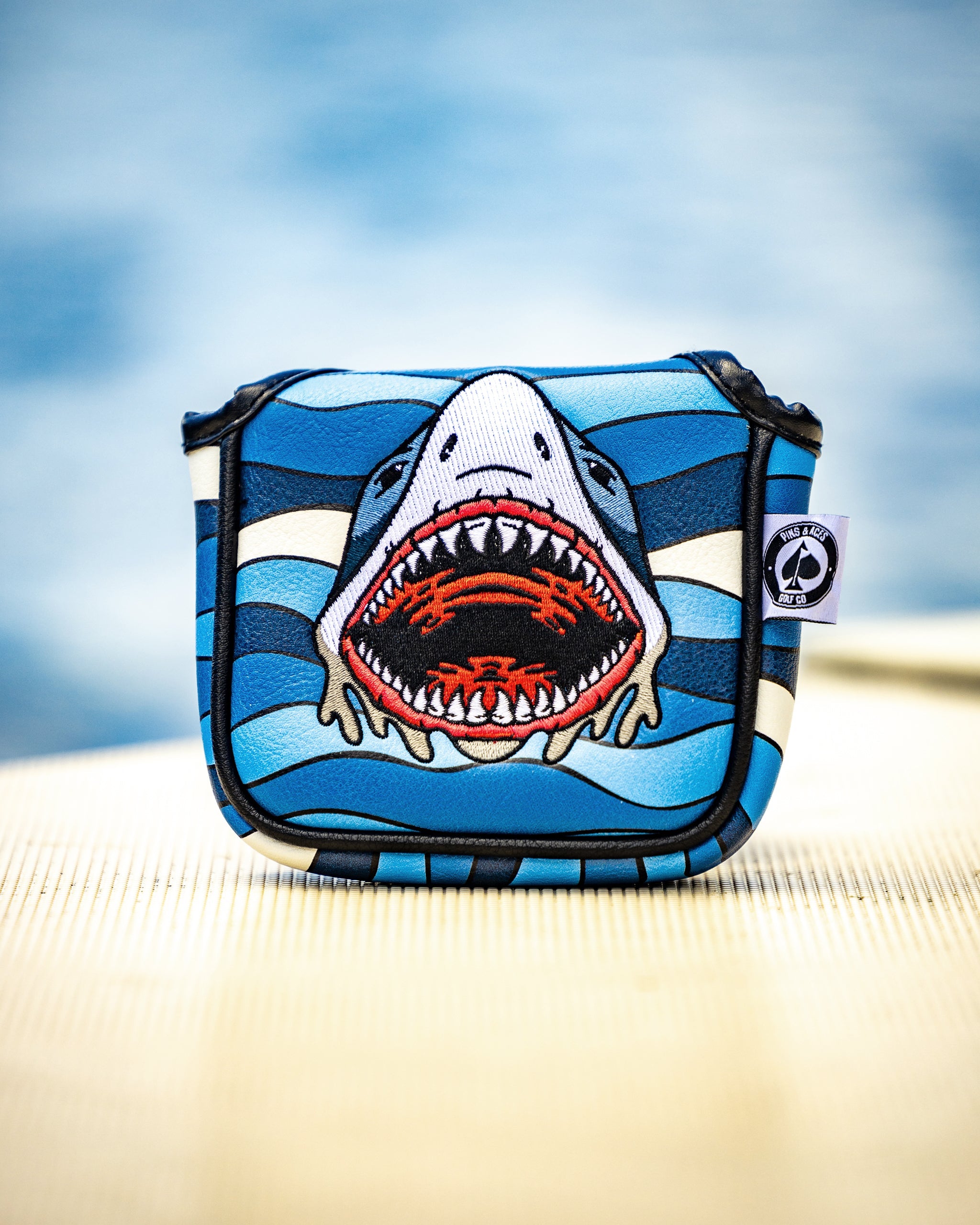 Shark Attack mallet putter cover with vibrant shark design and durable material, showcased in an outdoor setting.