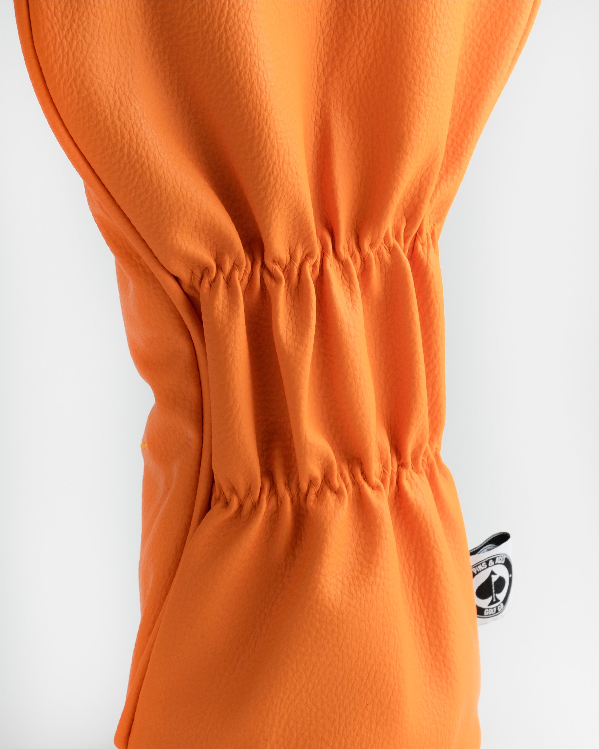 Kenny McCormick driver cover featuring South Park character design, in bright orange and yellow colors, with intricate details and embroidered elements.