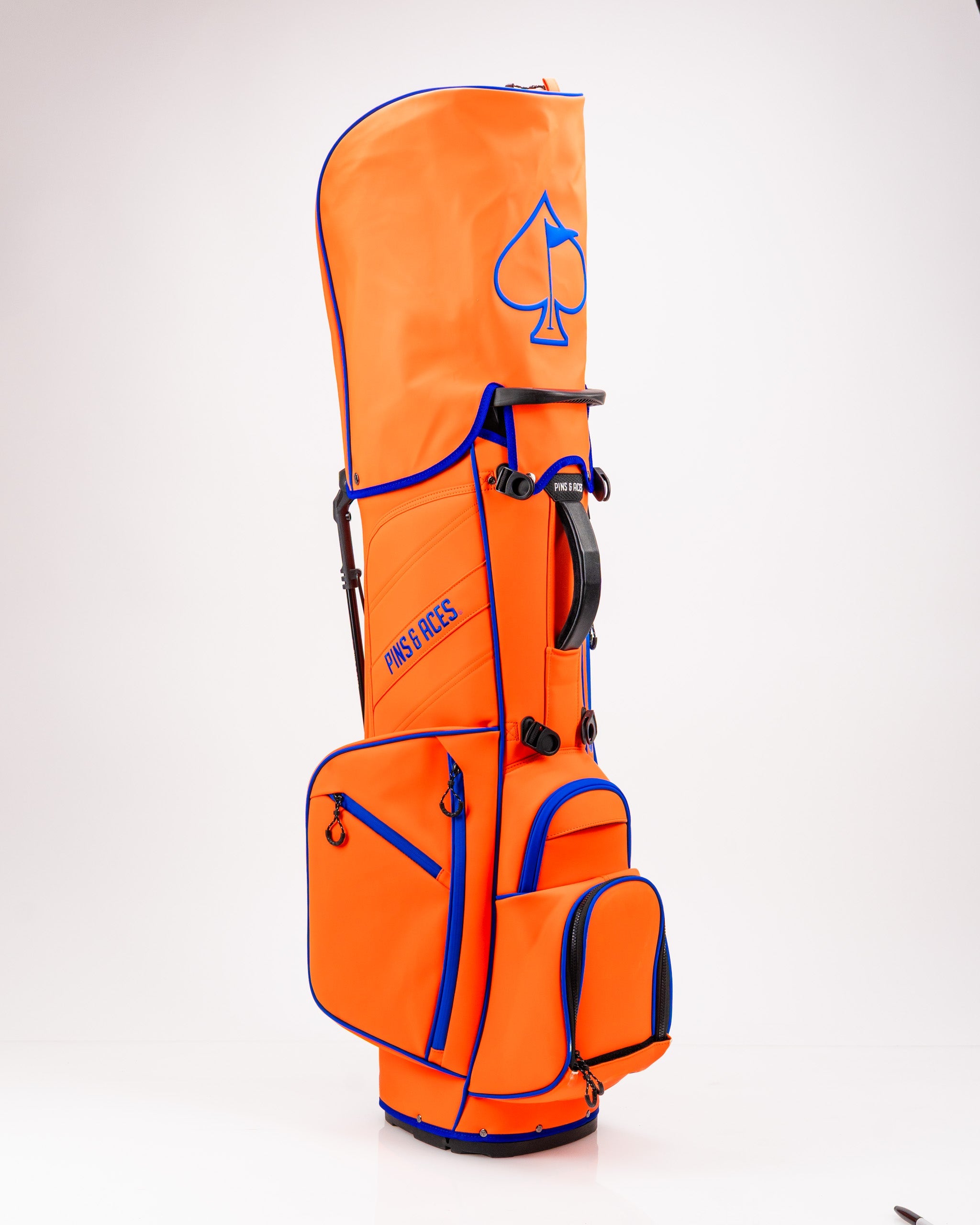 Alt text: Player Preferred™ Golf Bag in vibrant Orange Crush color, featuring multiple pockets and shoulder straps for easy carrying on the golf course.