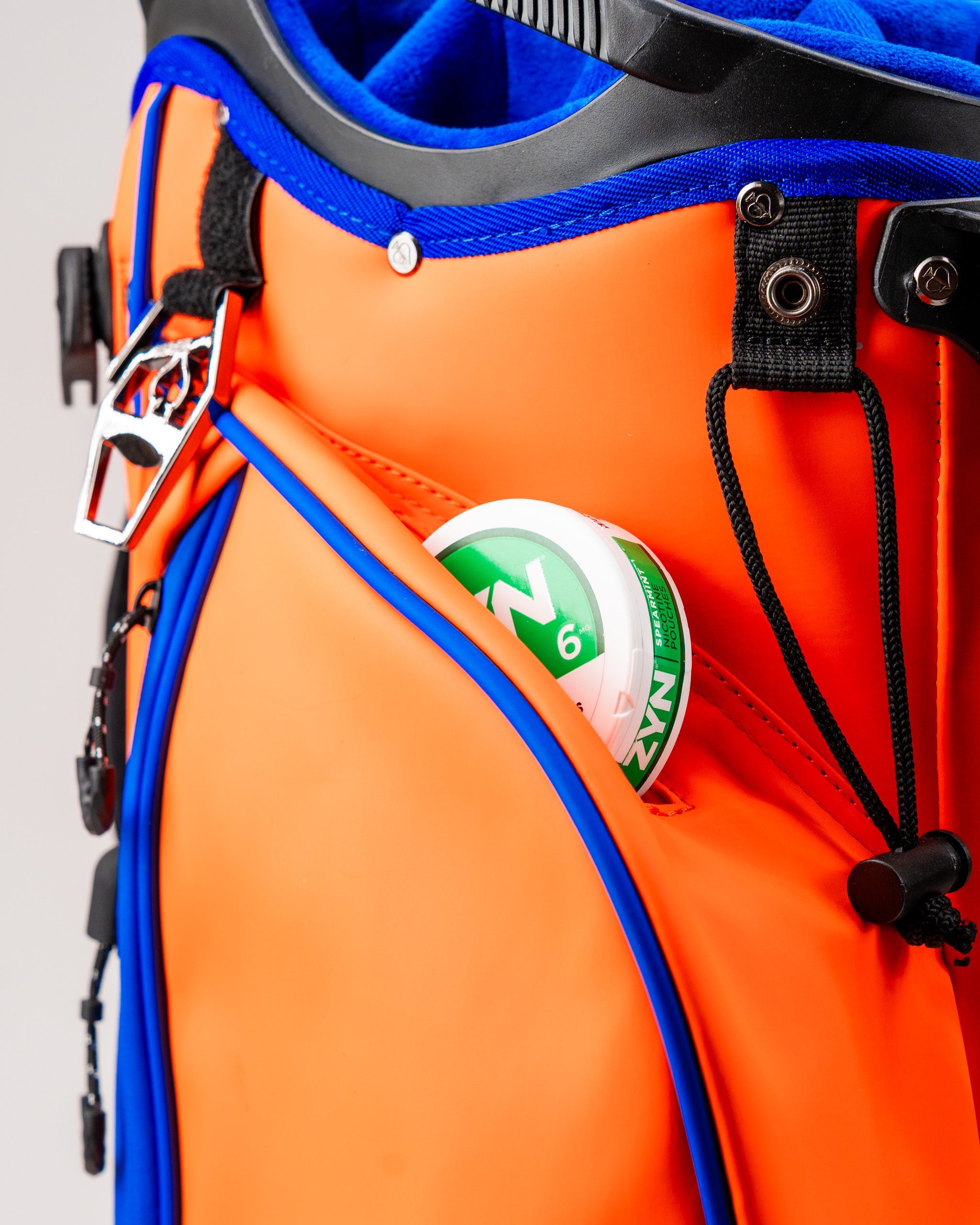 Player Preferred™ Golf Bag in vibrant orange with contrasting black accents, featuring multiple pockets and a comfortable shoulder strap.