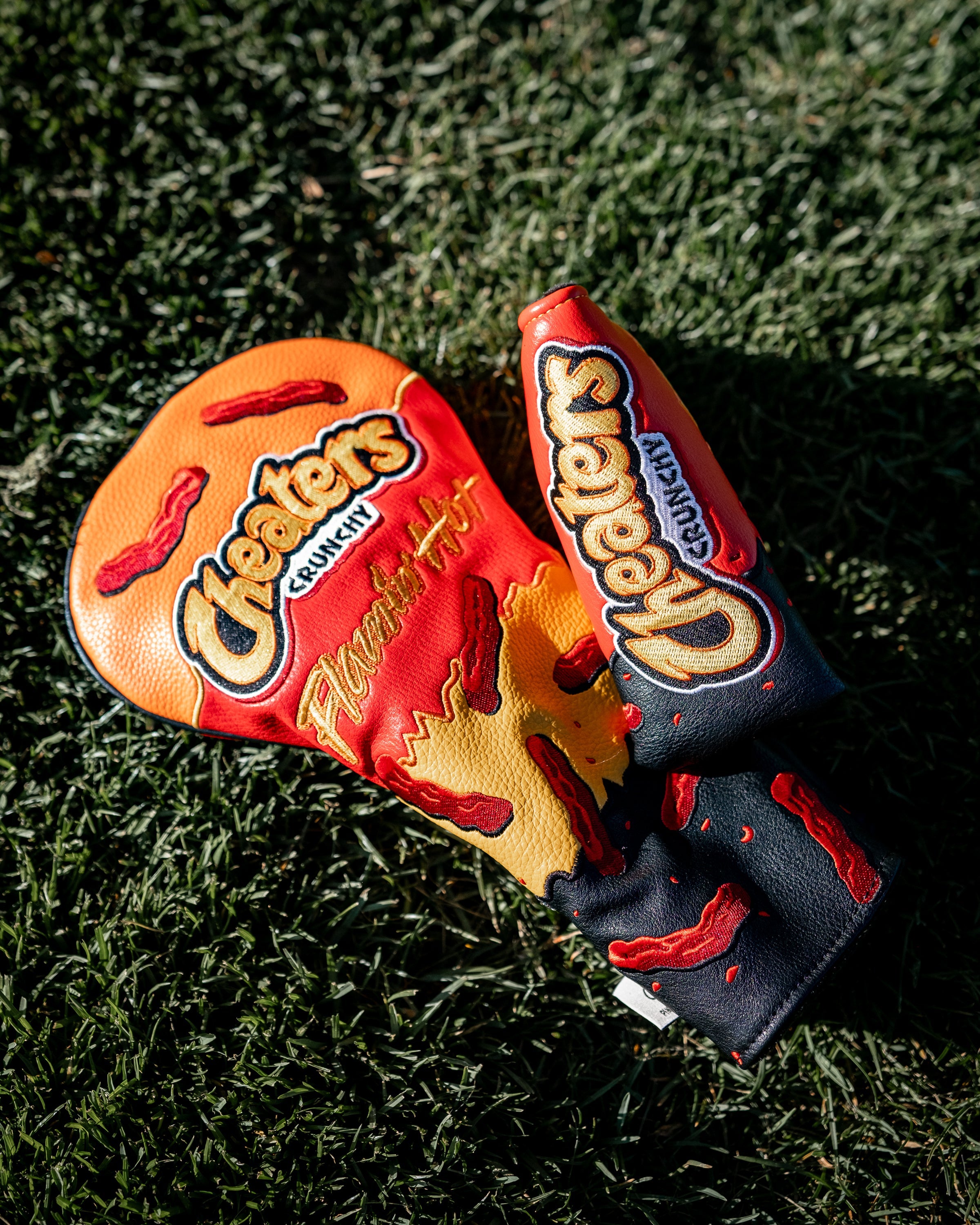 Golf club headcover and glove featuring a spicy Flamin' Hot Cheaters design with chili pepper graphics and bold branding.