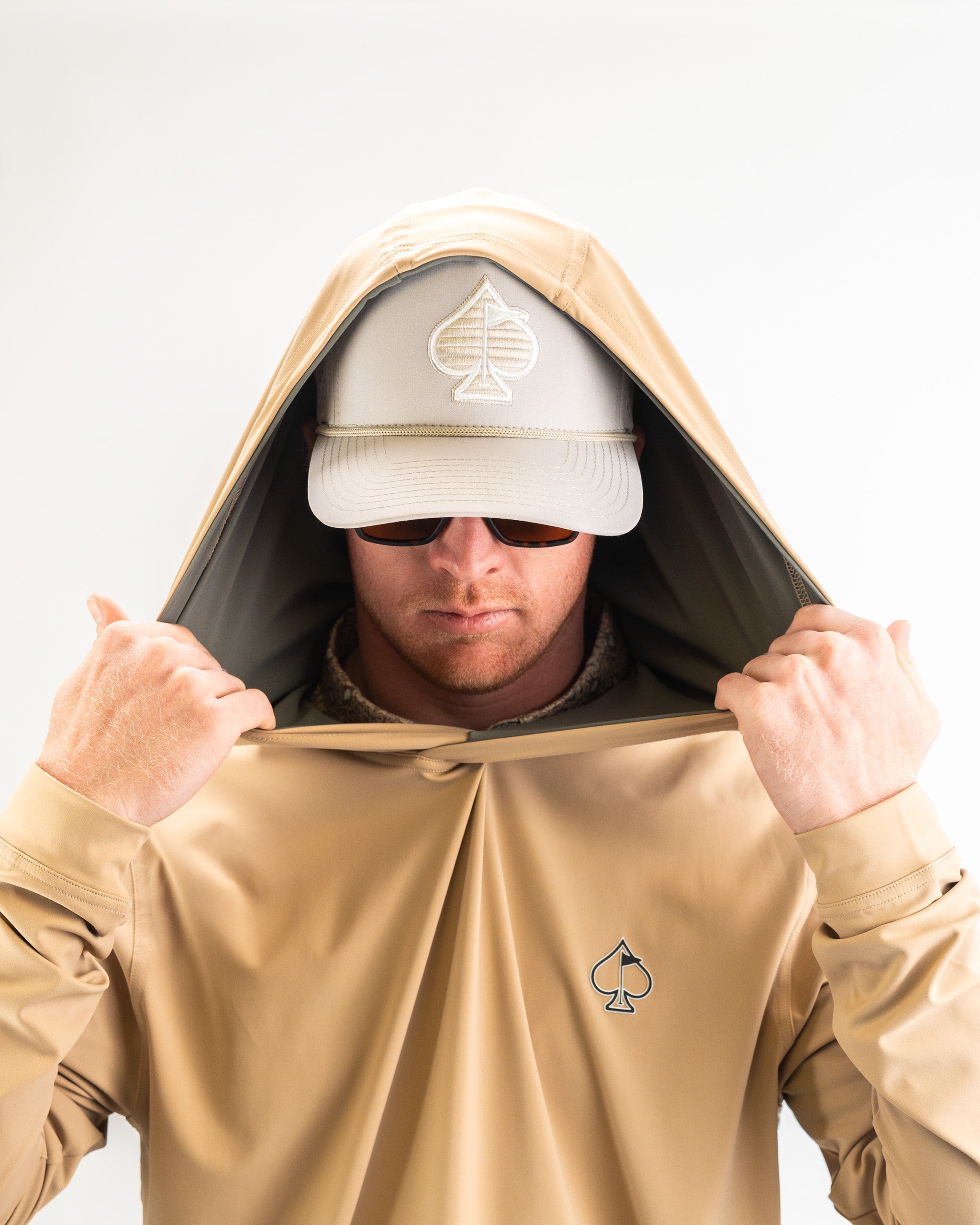 Performance Golf Hoodie in Big Blind Sand color, showcasing a lightweight and stylish design with a functional hood and front pocket.