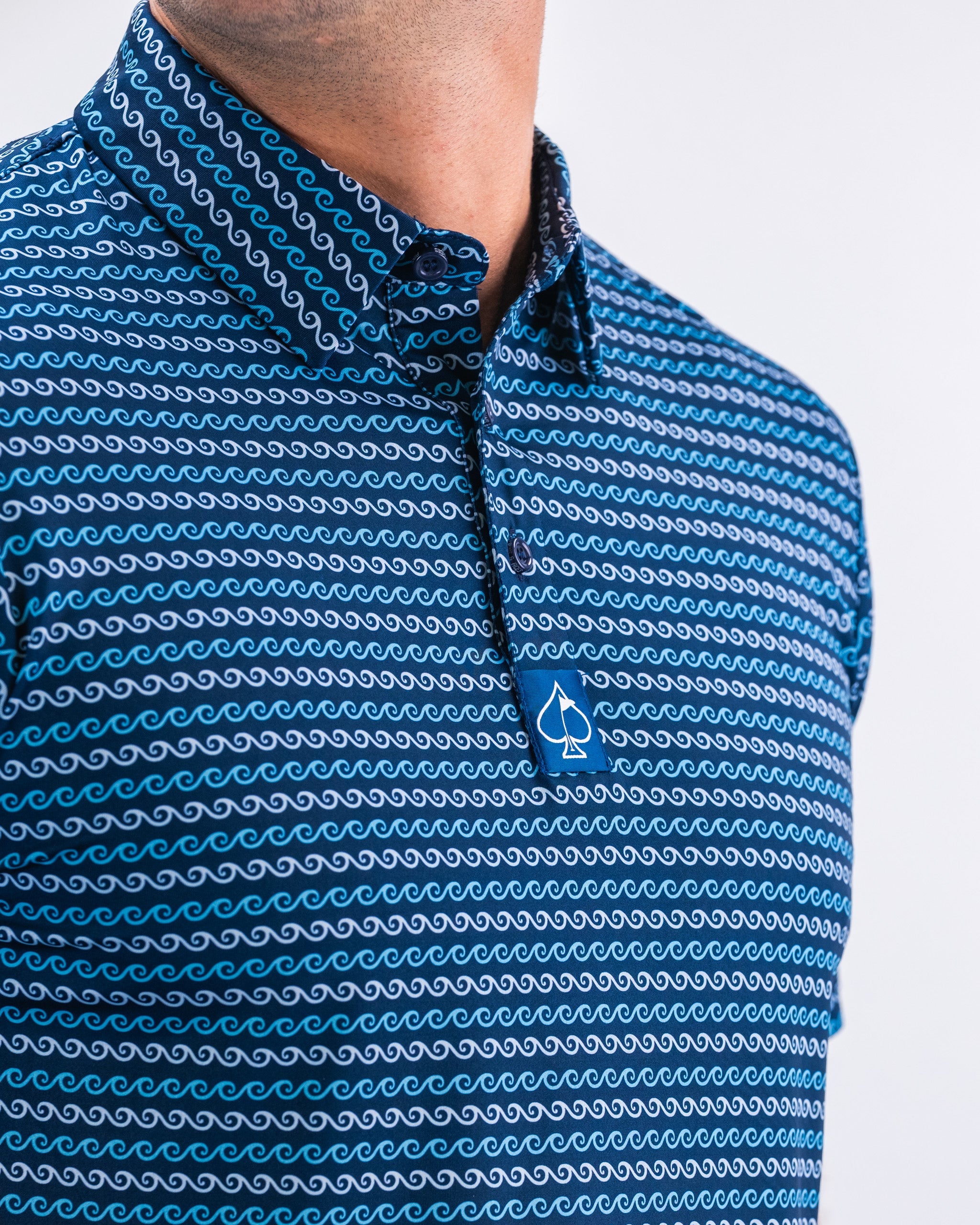 Men's Rising Tides shirt featuring a vibrant ocean wave design in blue and white.