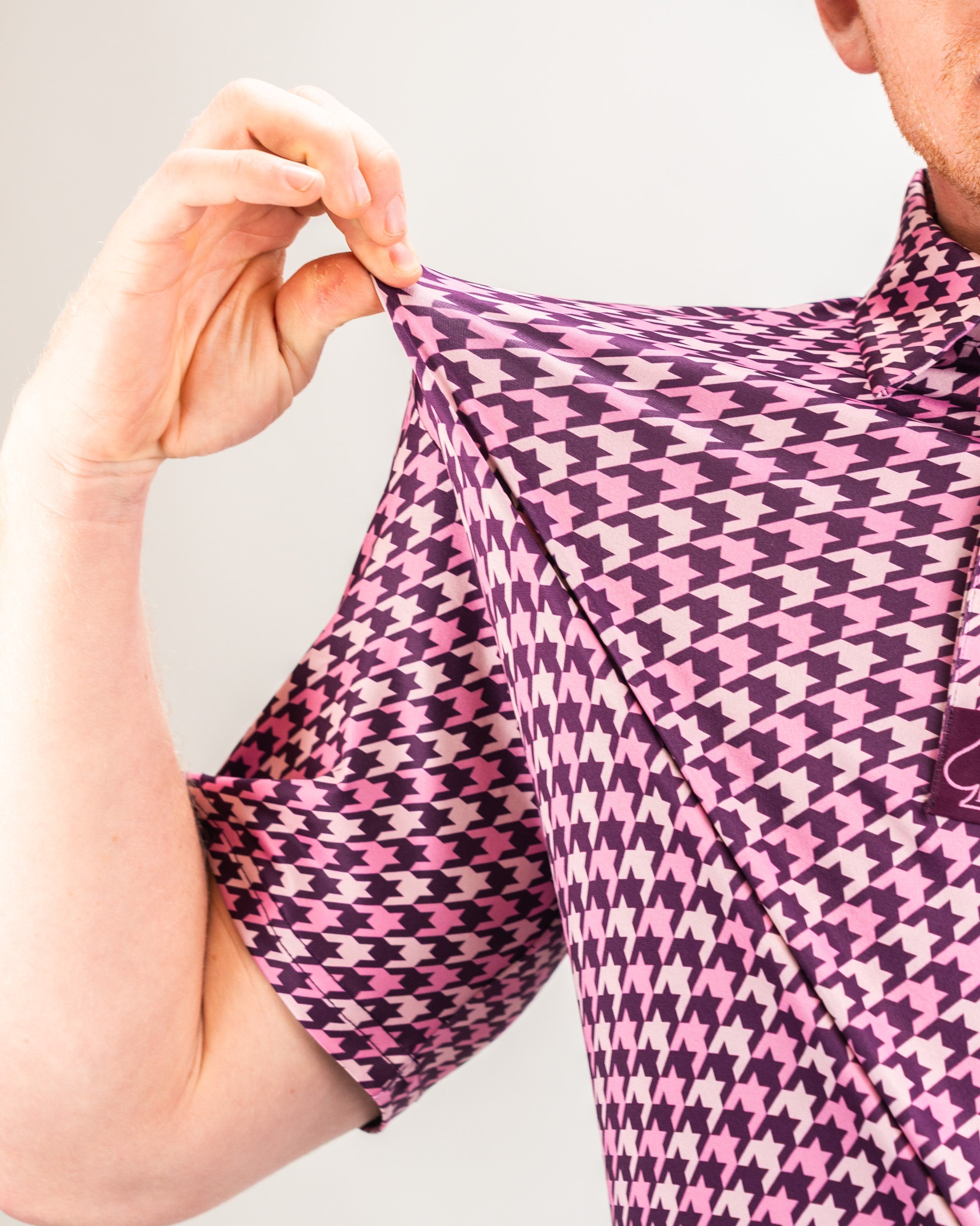 Men's houndstooth patterned shirt in raspberry color, featuring a classic collar and button-down front.