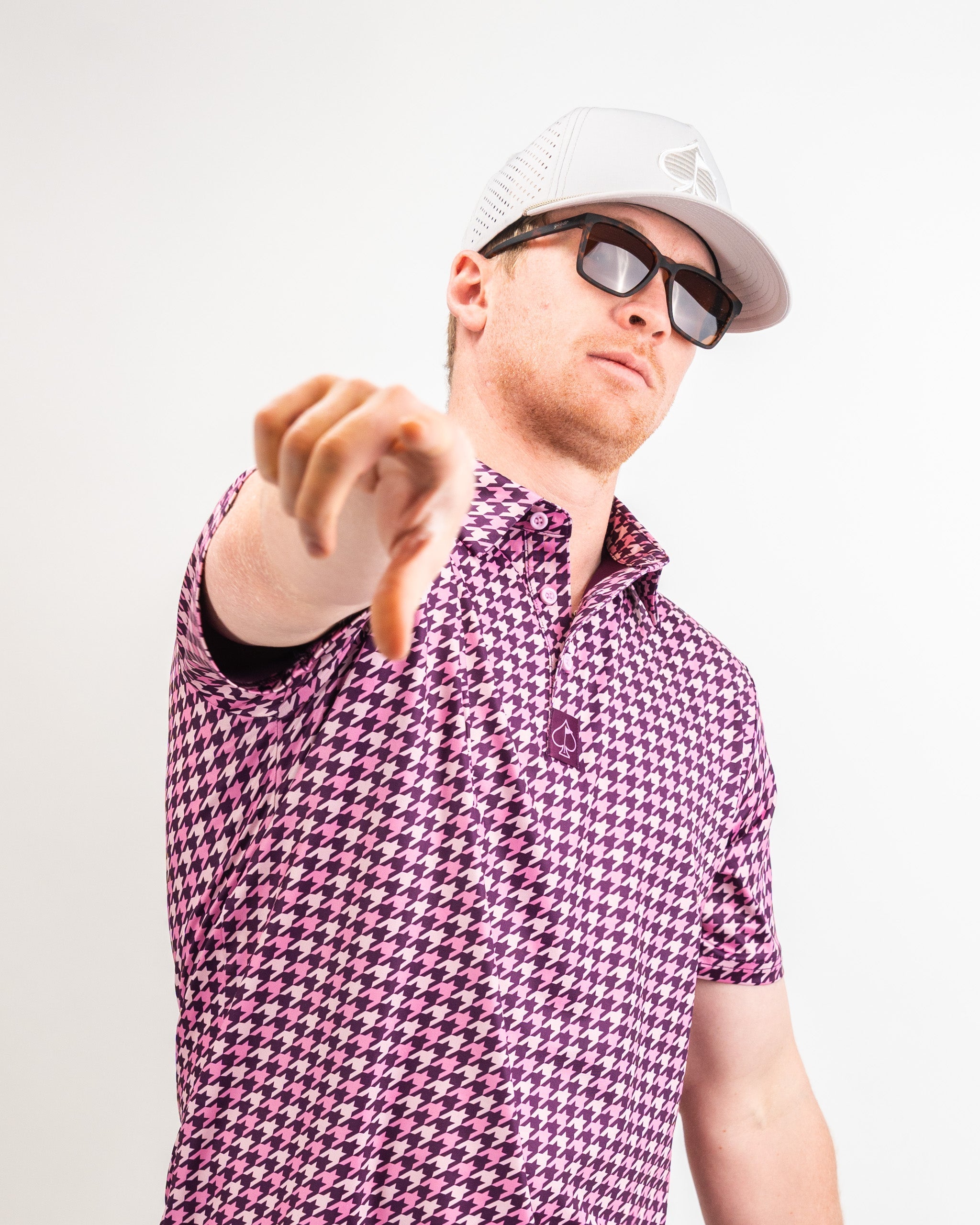 Houndstooth-patterned fabric in vibrant raspberry color, showcasing a stylish design suitable for menswear.