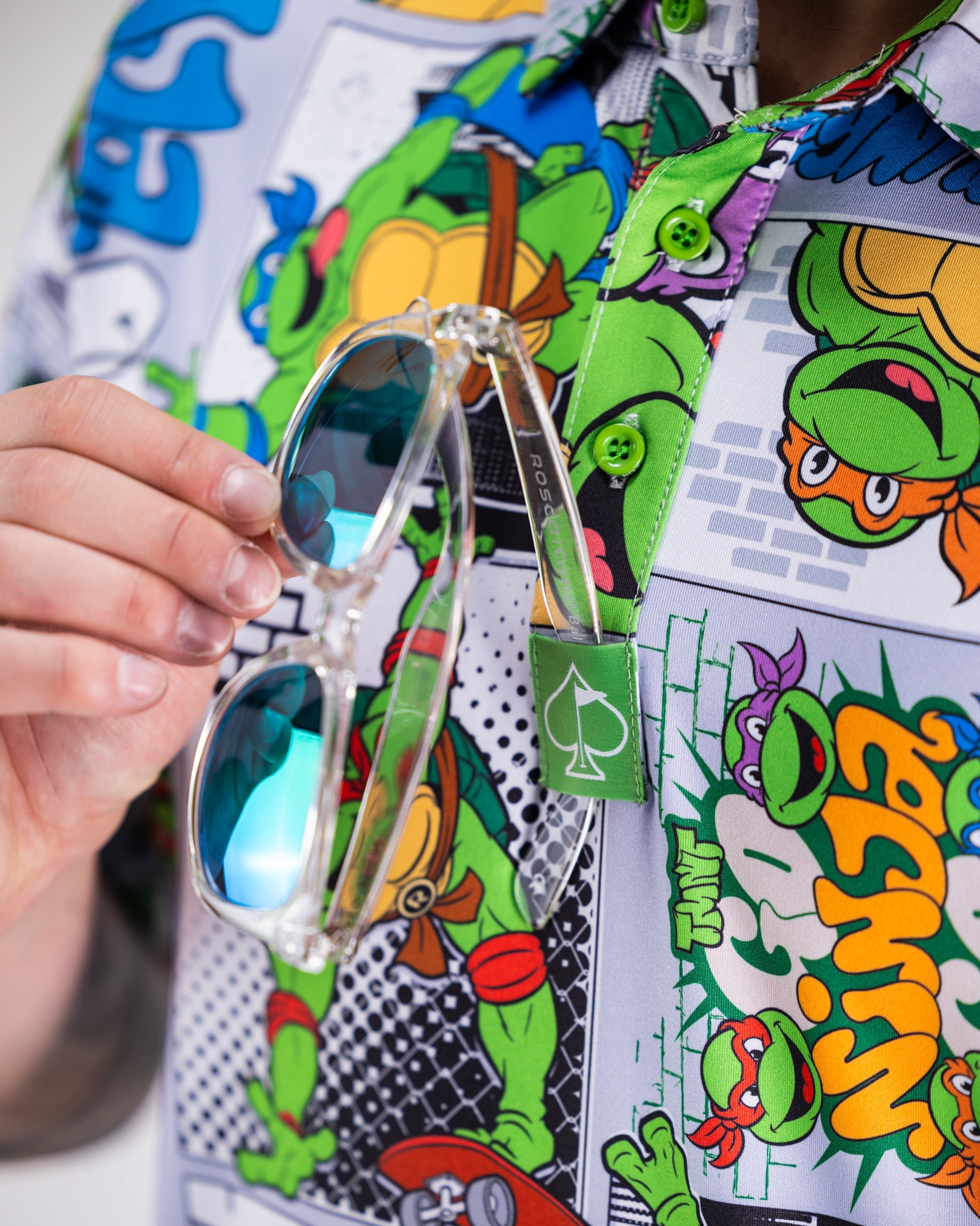 TMNT comic strip graphic on a polo shirt featuring the Teenage Mutant Ninja Turtles.