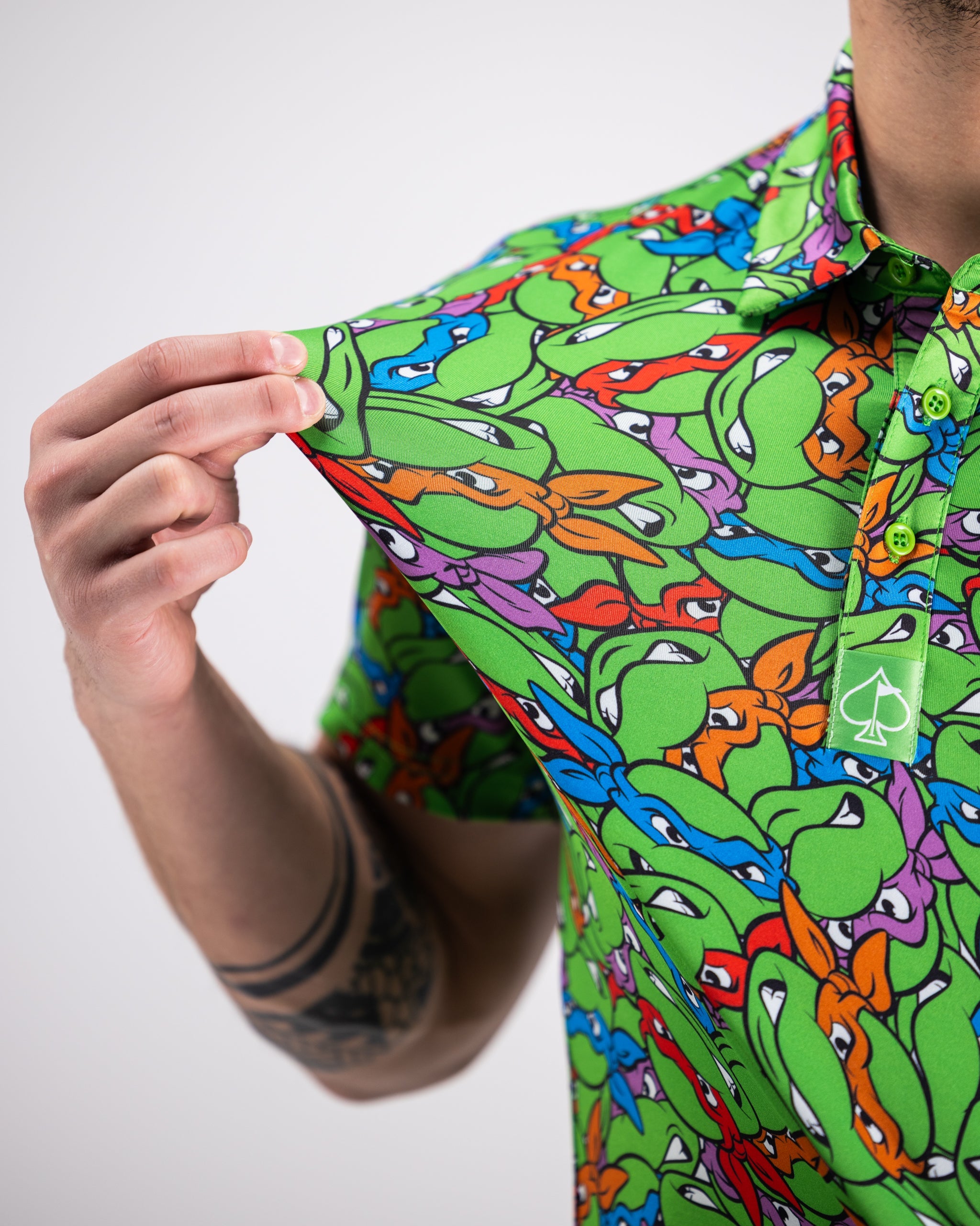 TMNT Mean Green Polo Shirt featuring turtle head design, vibrant green color.