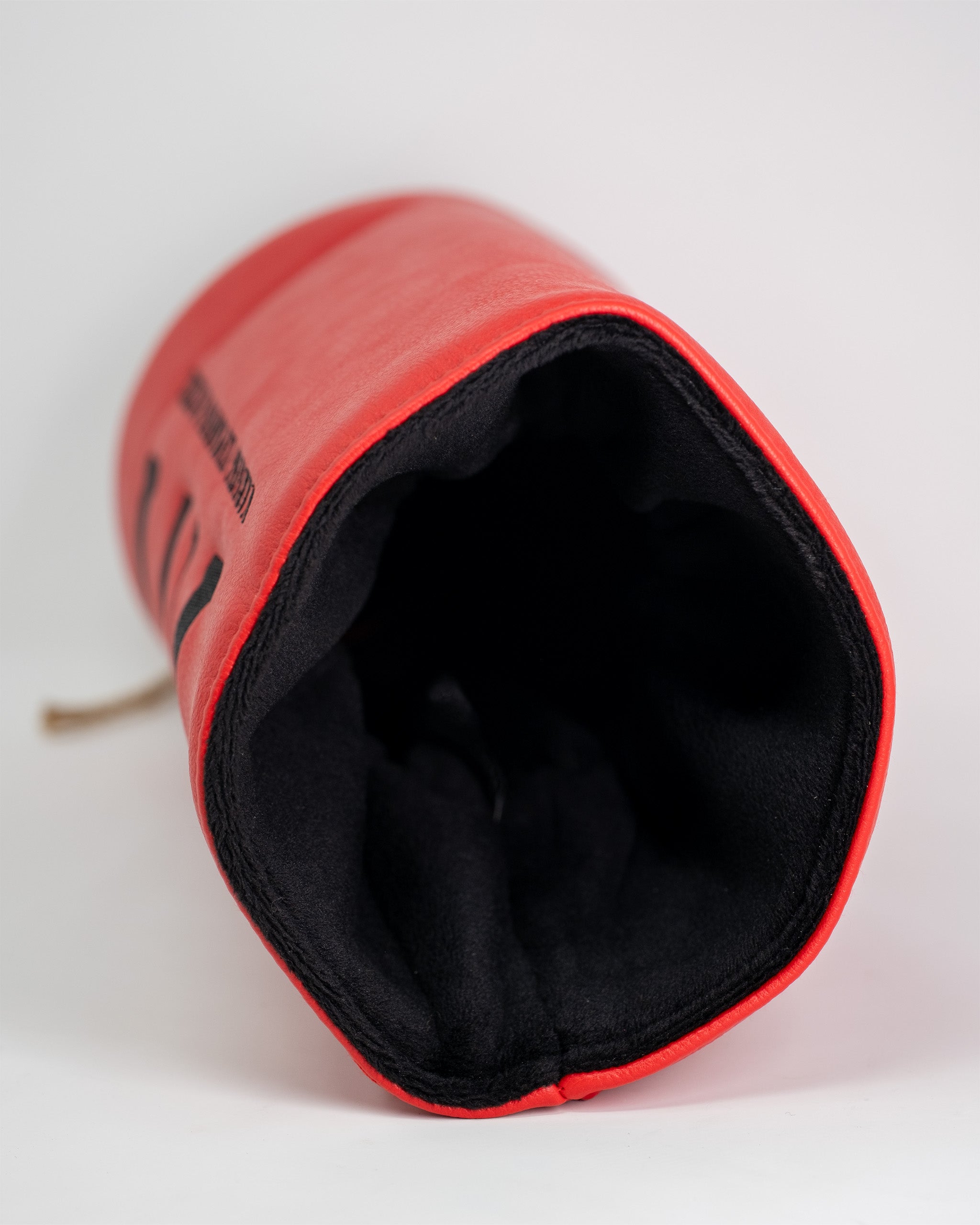 Red and black driver cover with padded interior, designed to protect golf club drivers during transport and storage.
