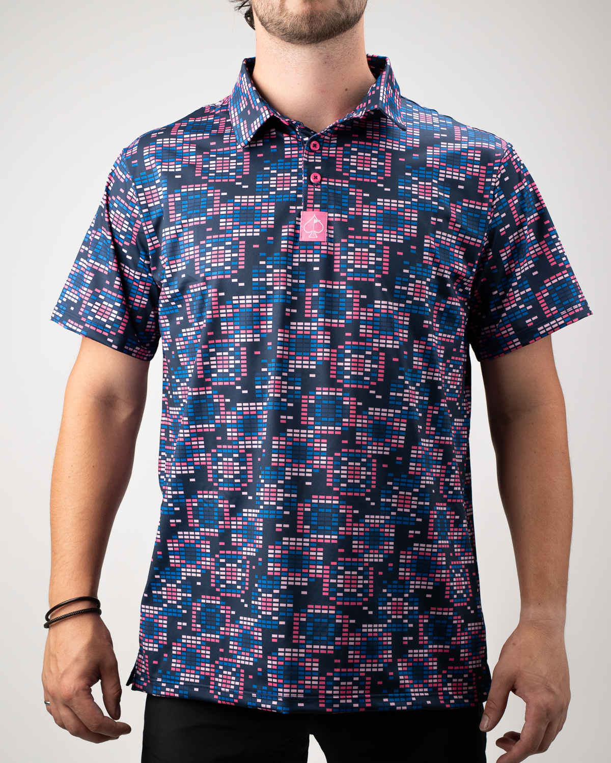 Men's Tetrafloral Dark golf shirt featuring a bold geometric pattern in navy, pink, and teal, perfect for stylish play on the course.