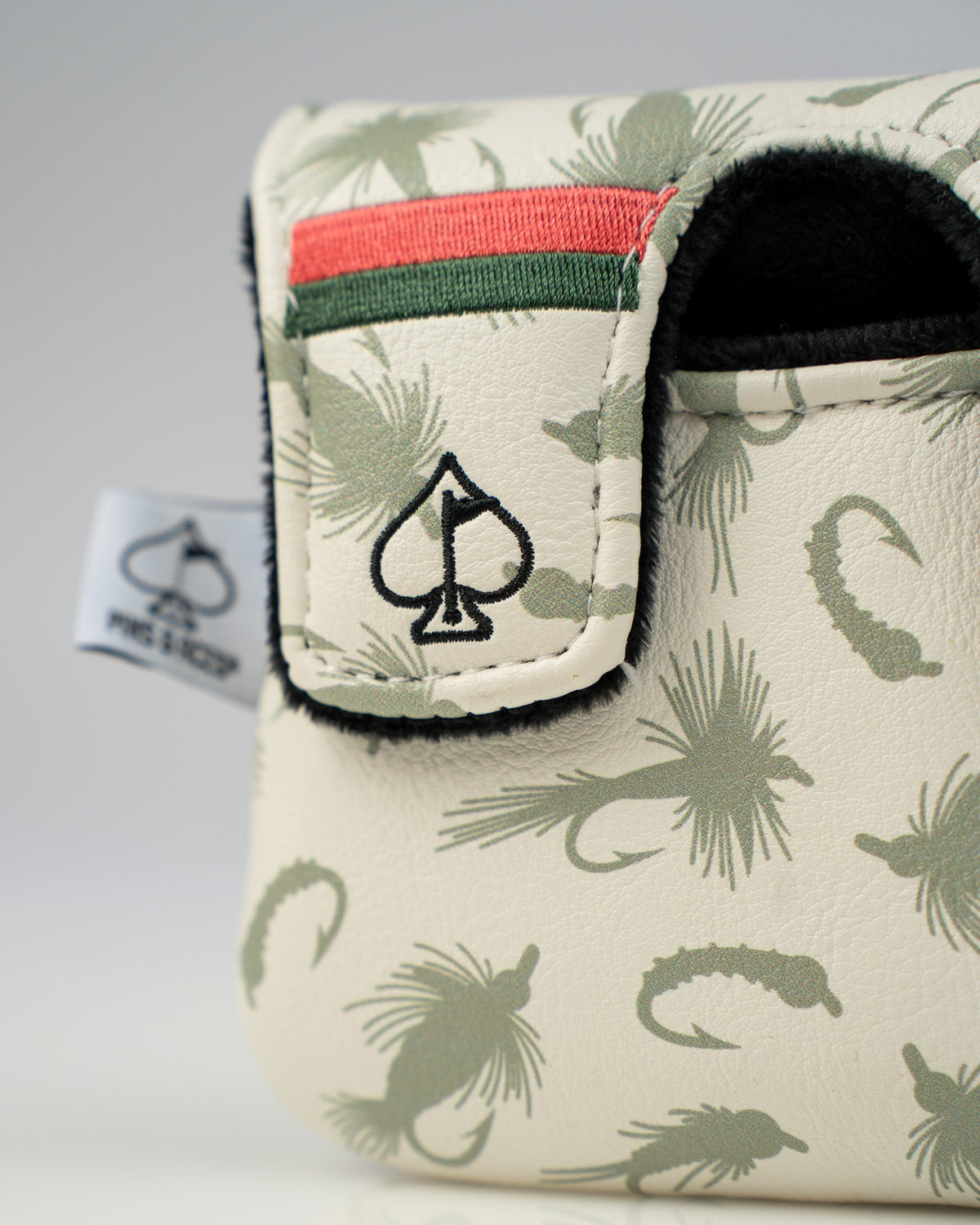 Center shaft mallet putter cover featuring a trout design with a spade logo and green and red accents.