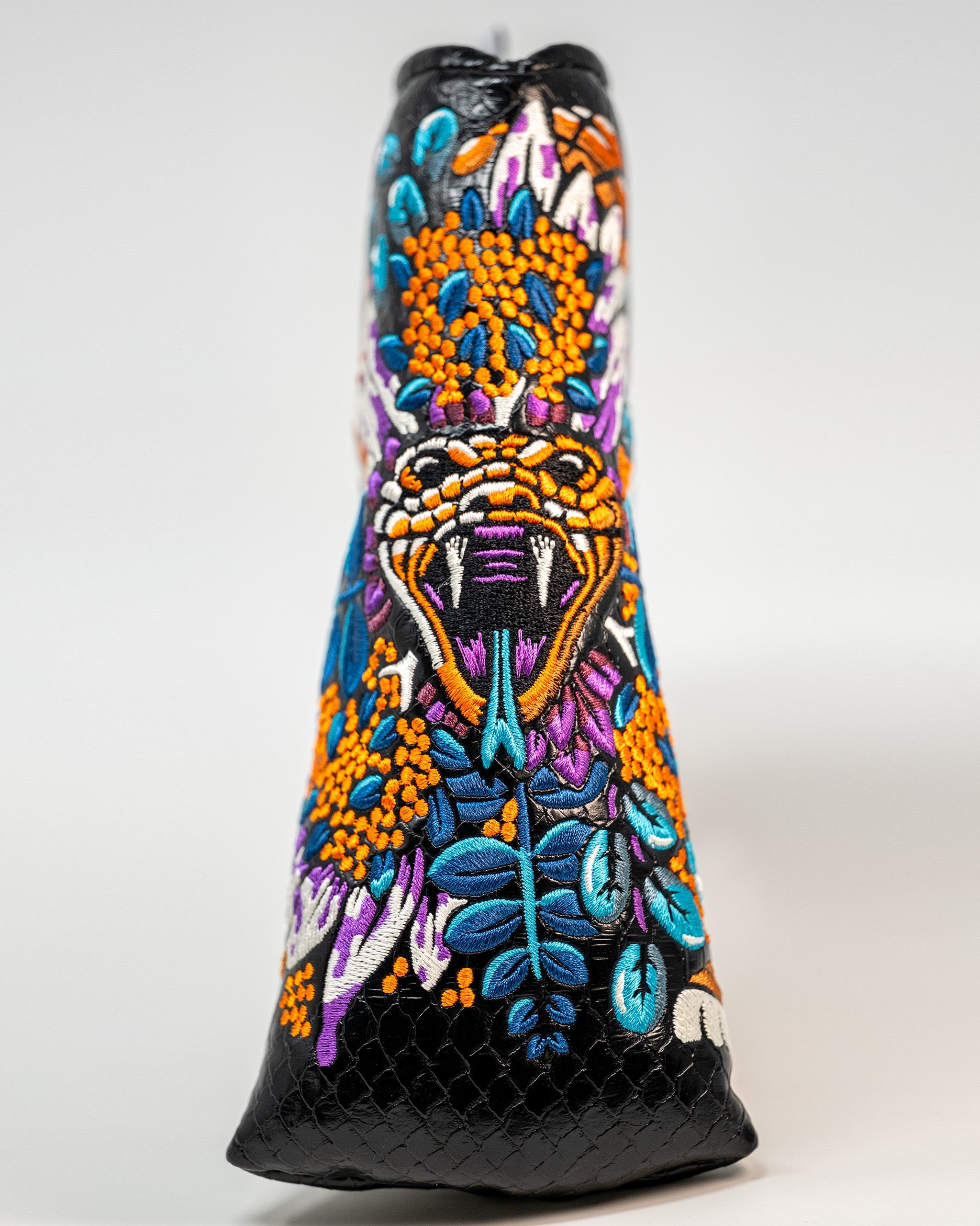 Venom Blade Putter Cover featuring a sleek design with venomous snake graphics and a durable, padded exterior for protection.