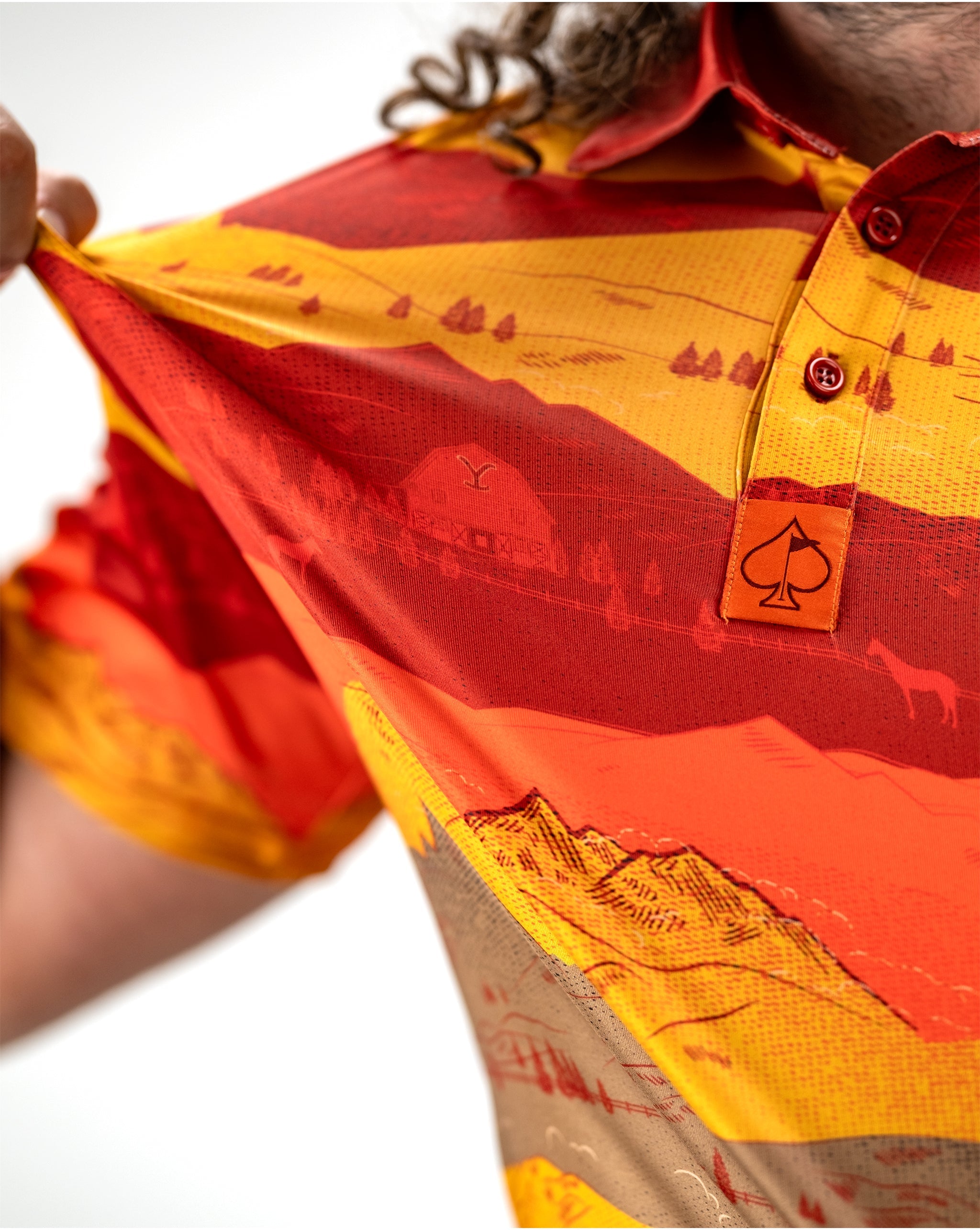 Alt text: "Vibrant sunset over Yellowstone National Park, showcasing orange and purple hues in the sky with silhouetted mountains."