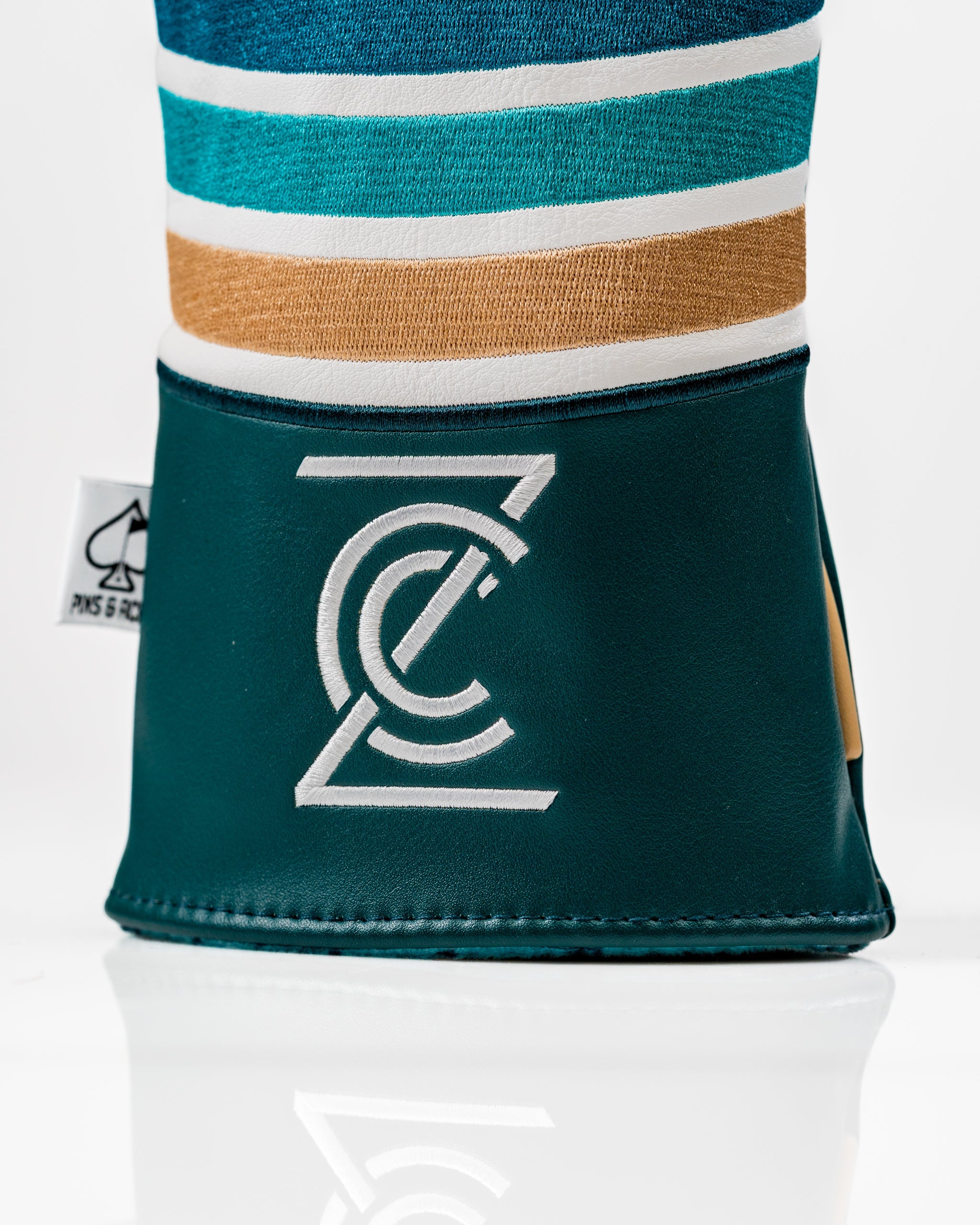 Bold driver cover featuring a gator design with vibrant stripes and a sleek logo, perfect for stylish golfers.