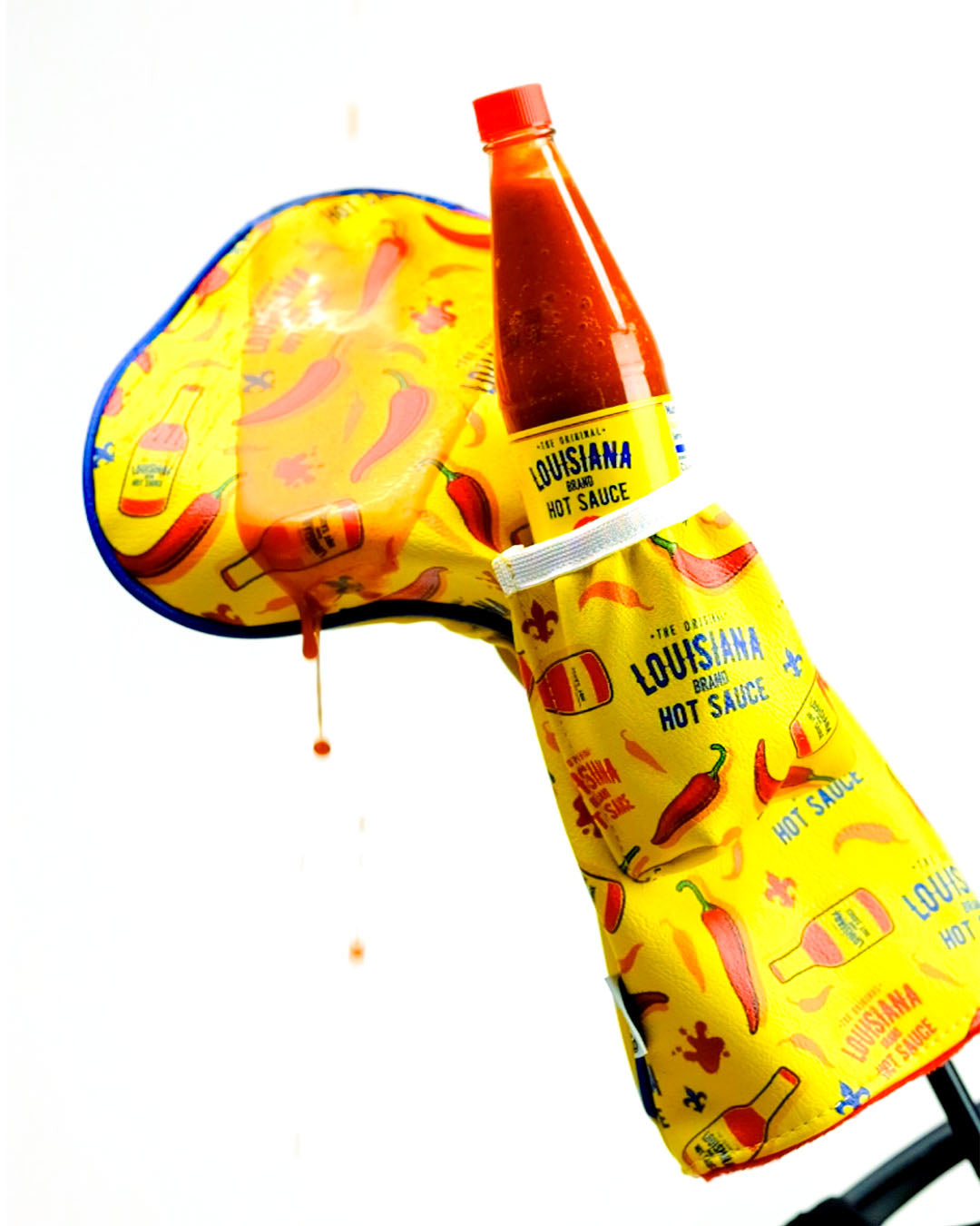Louisiana Hot Sauce driver cover featuring vibrant red and green design with hot sauce branding.